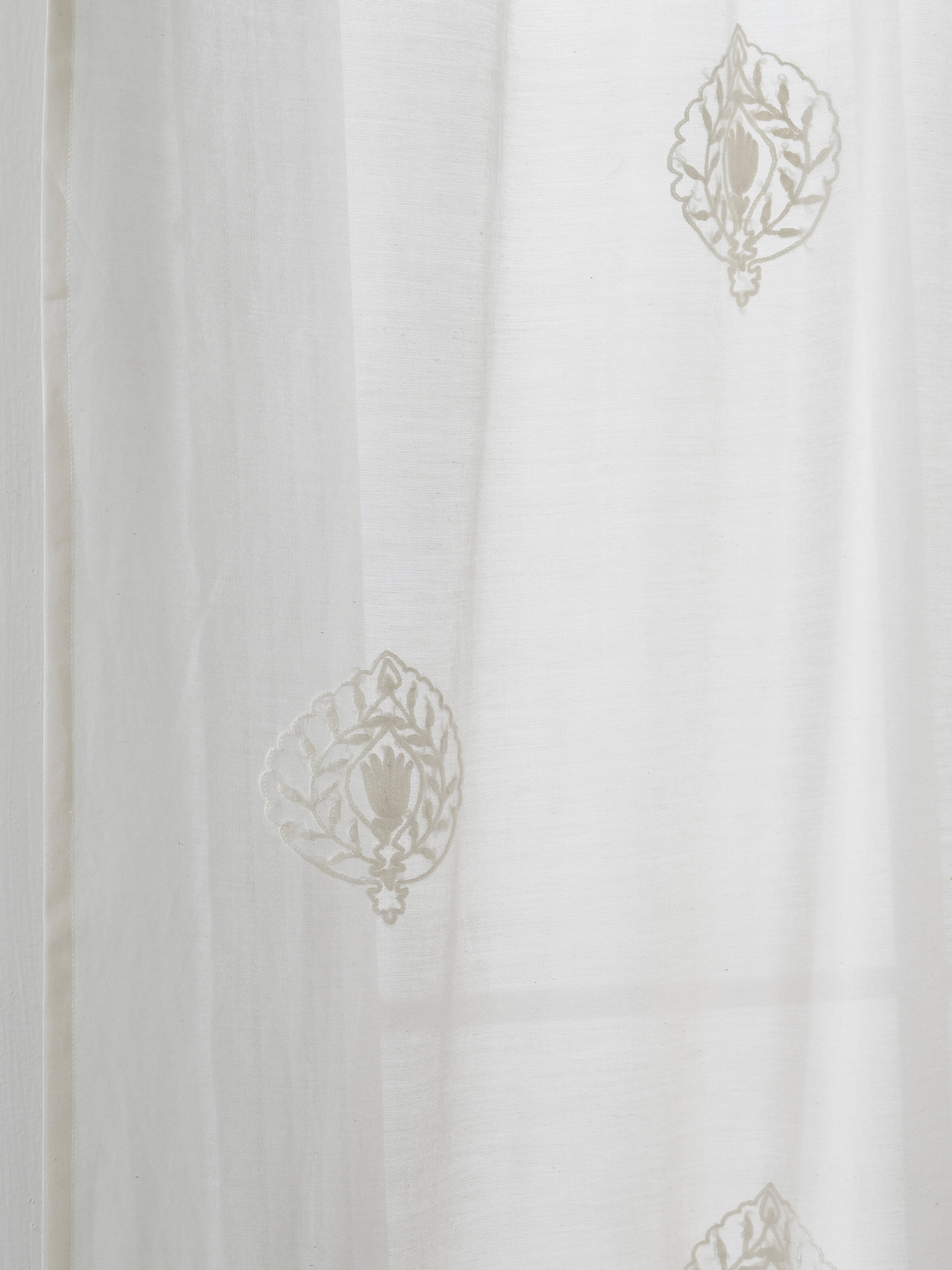 A macro detail shot of the embroidered Buti motif on the Razza Ivory Sheer Curtain, crafted with fine Kashmir-style hand embroidery techniques.