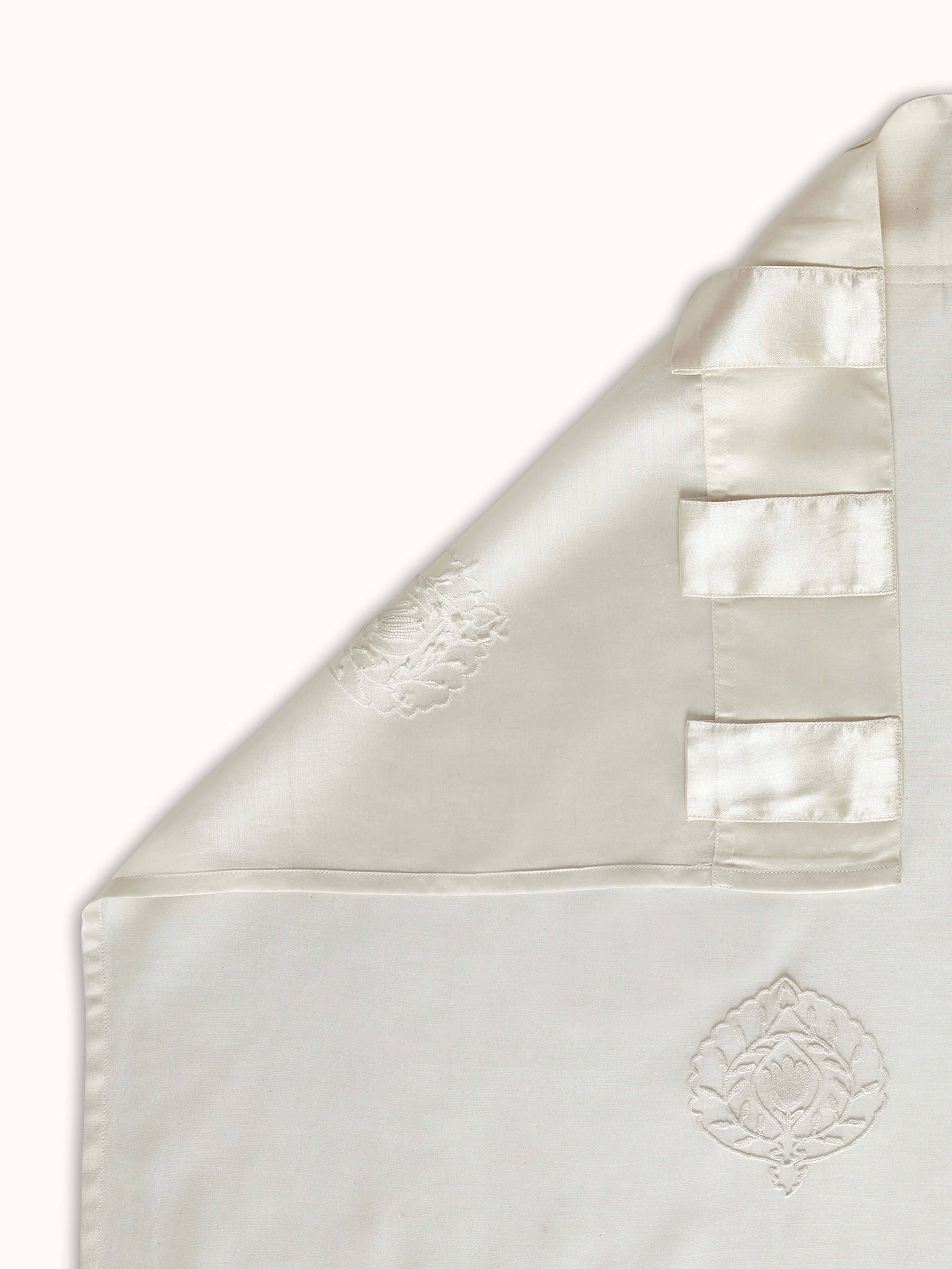A back view of the Razza Ivory Buti Curtain highlighting the transparency, stitch work, and natural texture of the cotton silk blend fabric.