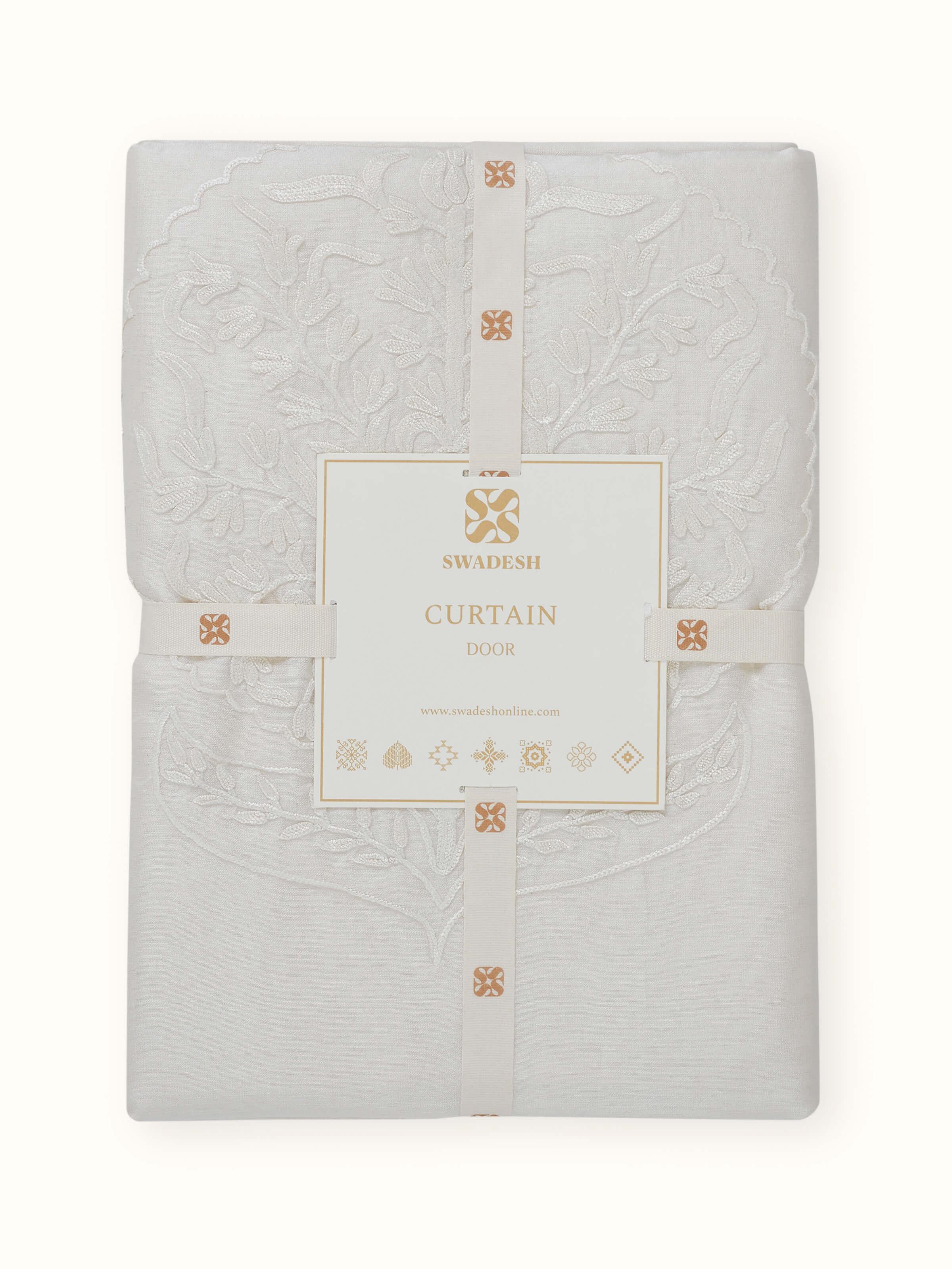 Angled view of Razza Cotton Silk Sheer Curtain, emphasizing the hand-embroidered floral motifs.