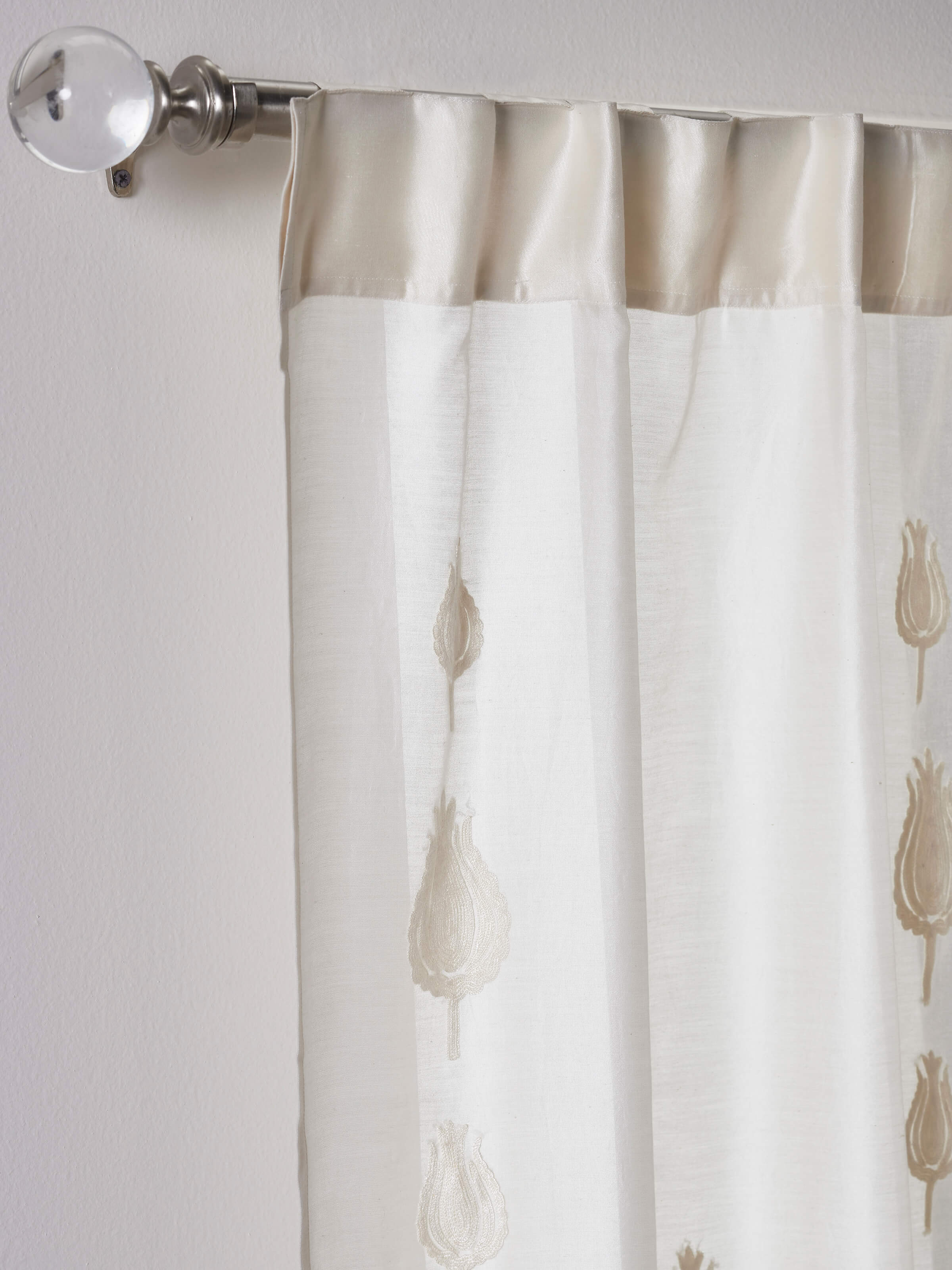 Front view of ivory sheer curtain with tulip buti embroidery and fine cotton silk texture.