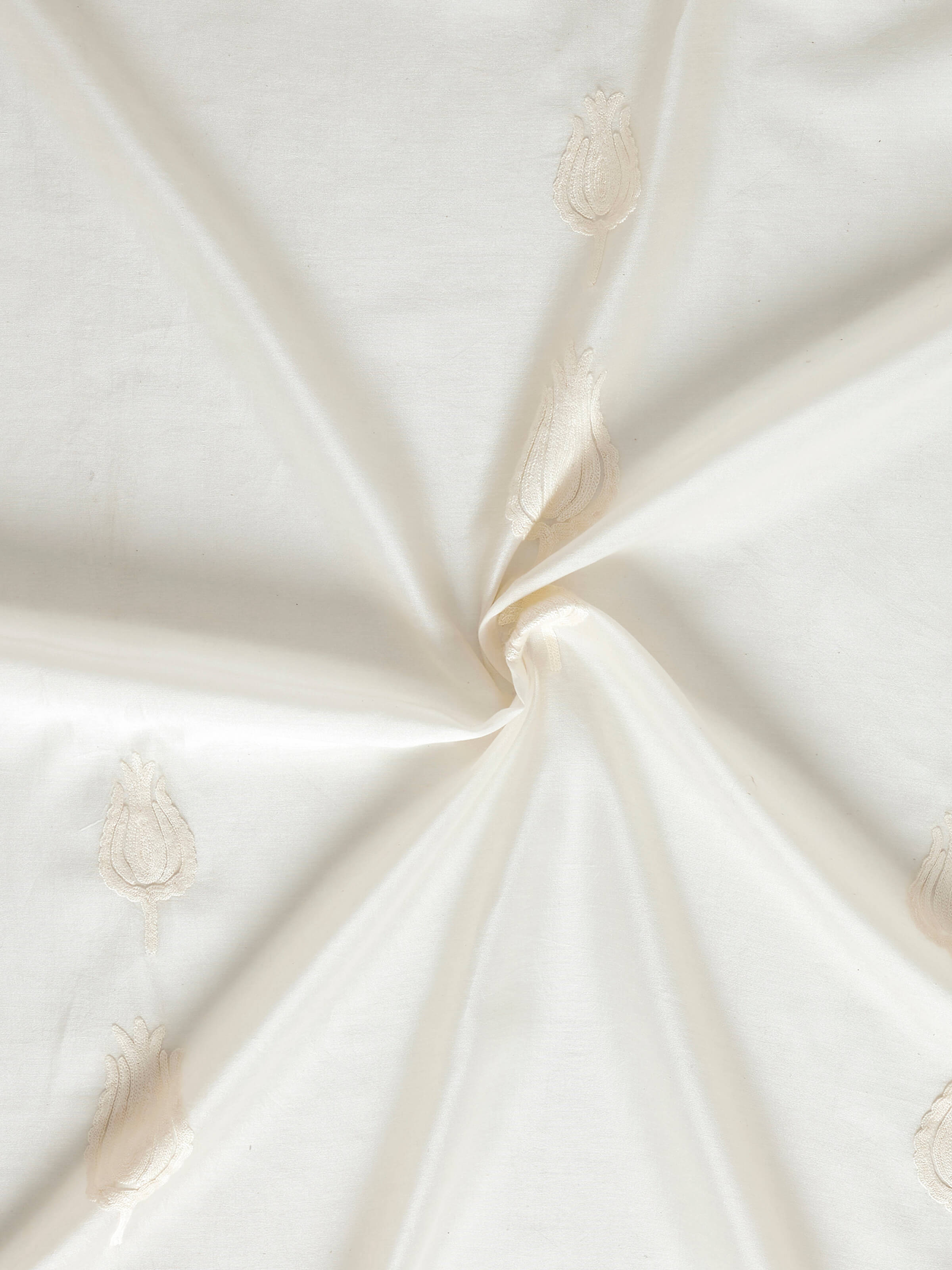 Detail shot of lower hem of sheer curtain showcasing translucent quality and design.