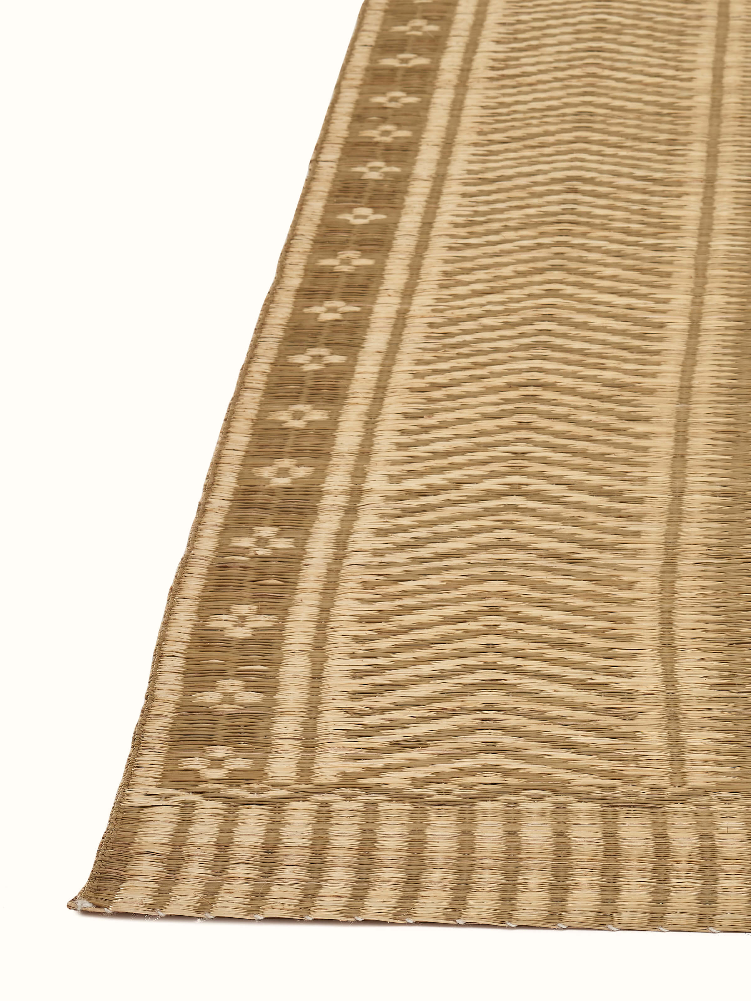 Detailed view of Folk geo beige West Bengal madurkathi natural fibre mat highlighting the pattern and texture.