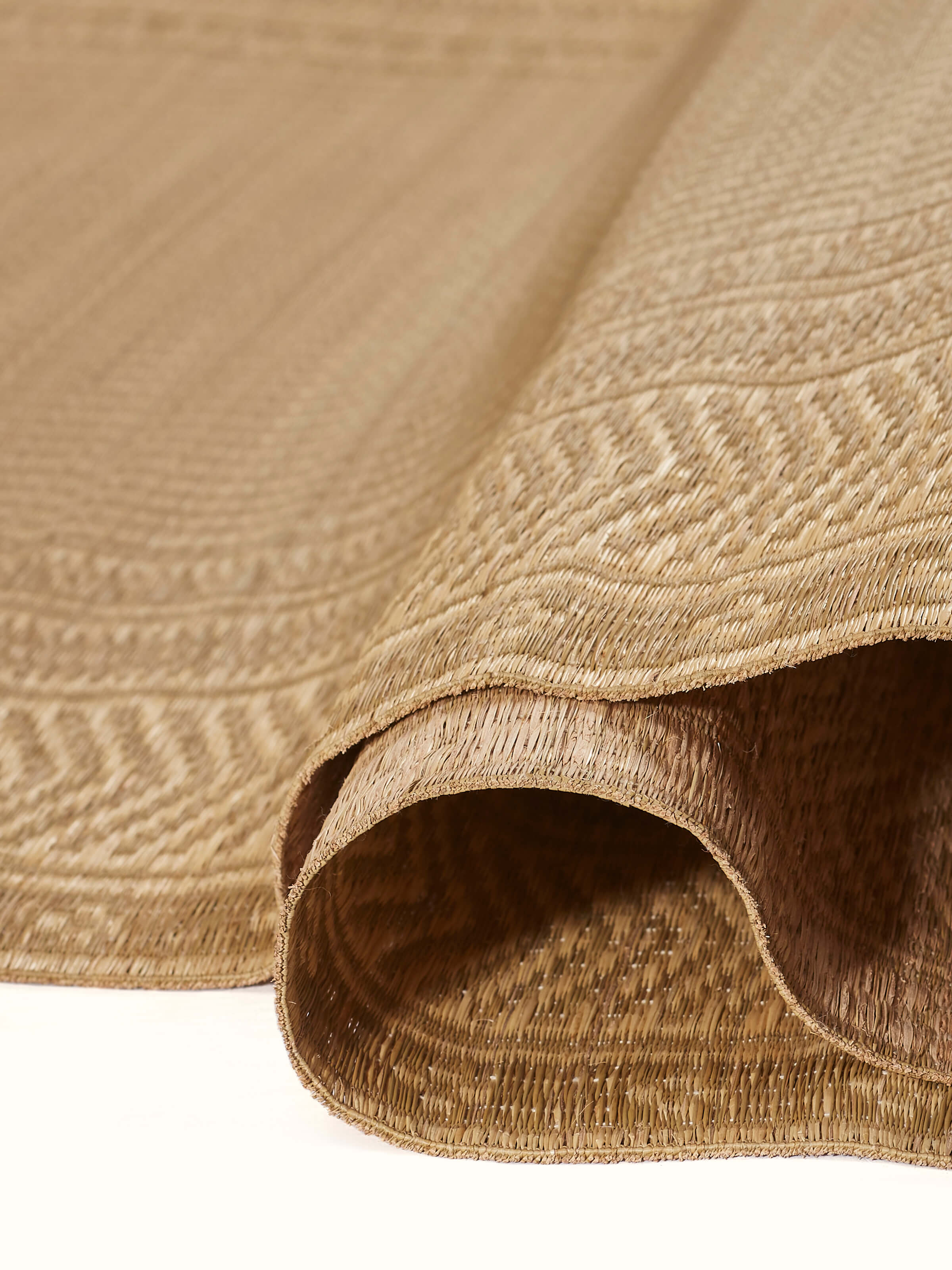 Close-up view of Folk geo beige West Bengal madurkathi natural fibre mat focusing on the details and craftsmanship.