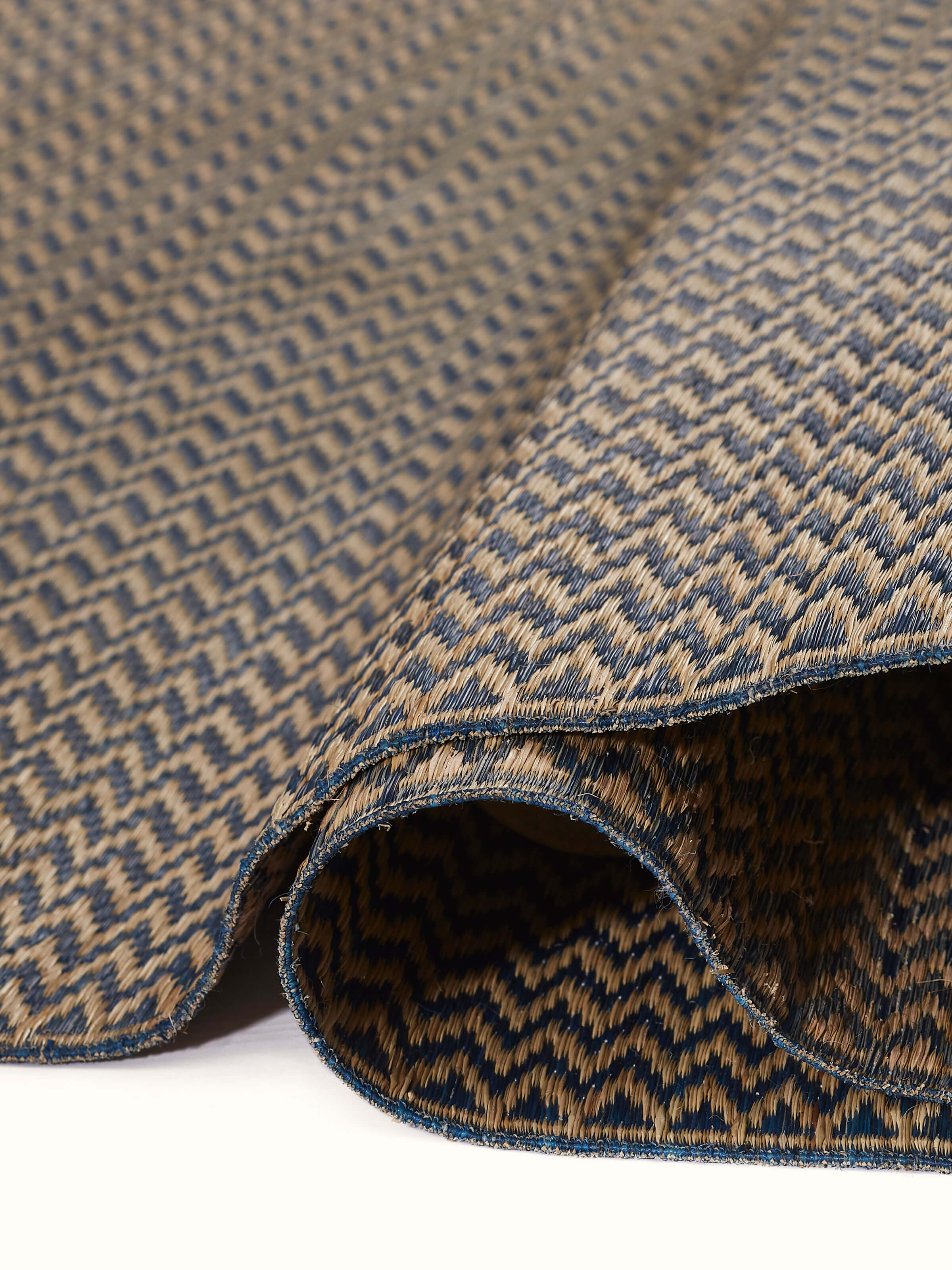 Close-up view of Folk geo dark turquoise West Bengal madurkathi natural fibre mat focusing on the intricate details.