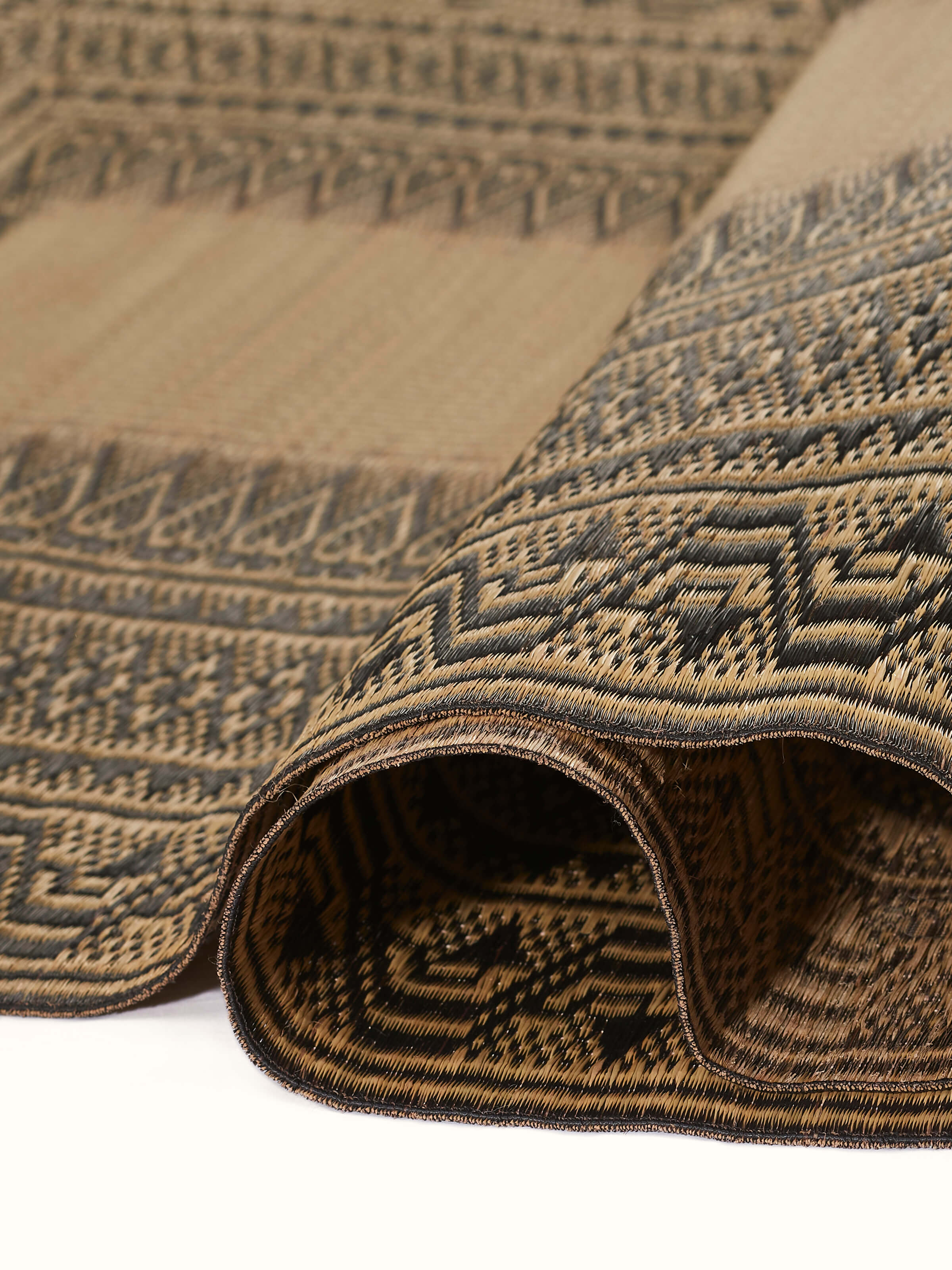Detail shot of Folk Geo Black West Bengal Madurkathi Natural Fibre Mat focusing on the intricate weaving and natural fibers.