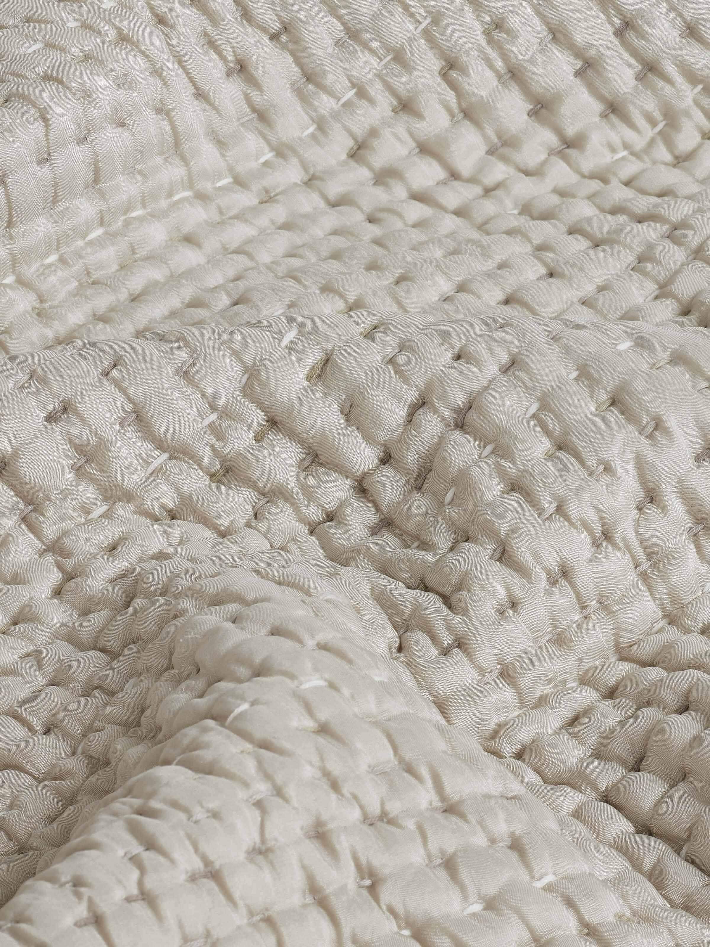 Ahilya grey textured silk razai embroidered double bedspread set displayed on a bed, showing its full design and use.