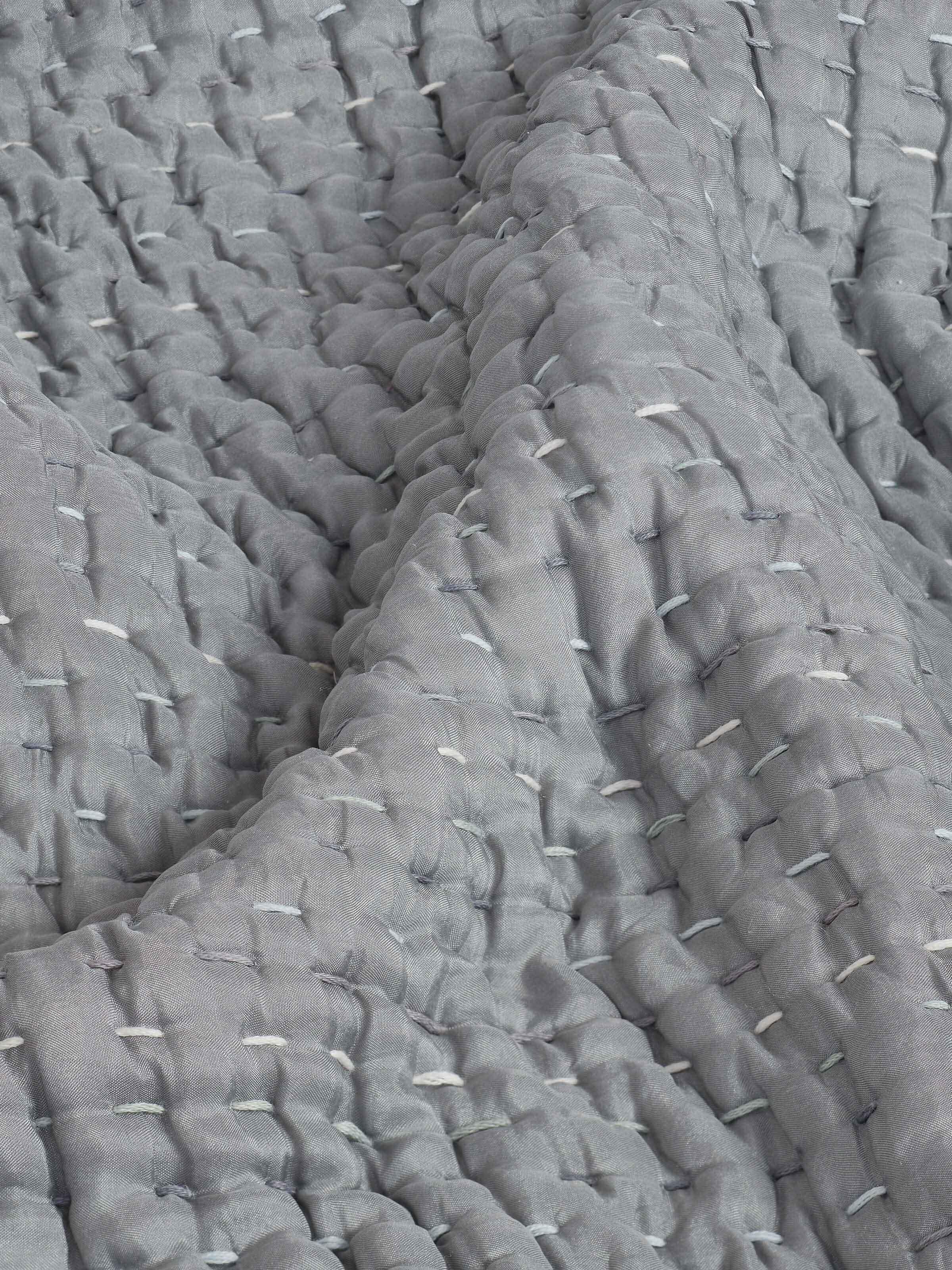 Side view of dark grey textured silk razai embroidered double bedspread set, focusing on the elegant embroidery and fabric quality.