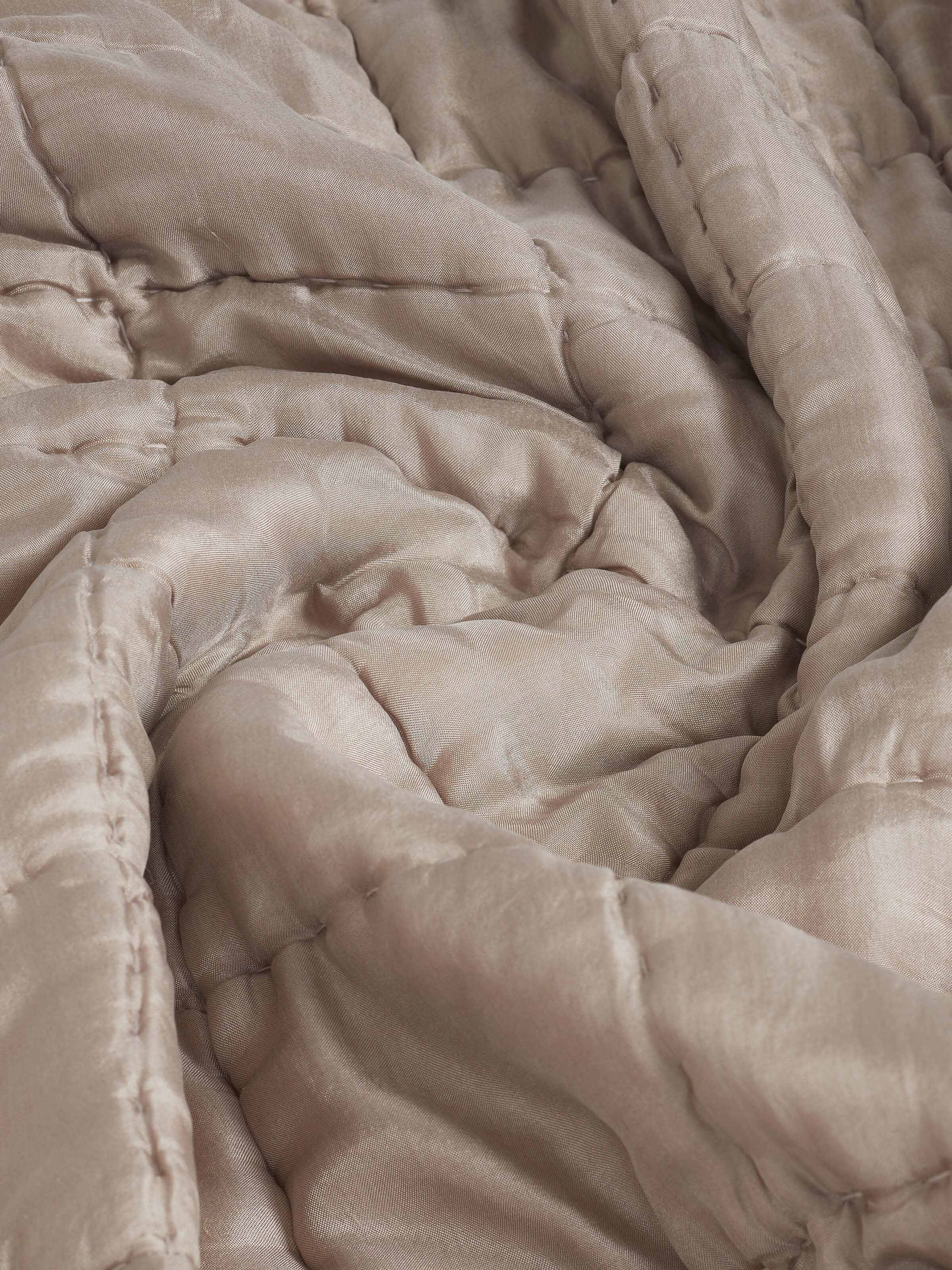 Detailed view of the Pipa Grey Silk Razai Bedspread Set showing the intricate embroidery on the silk fabric.