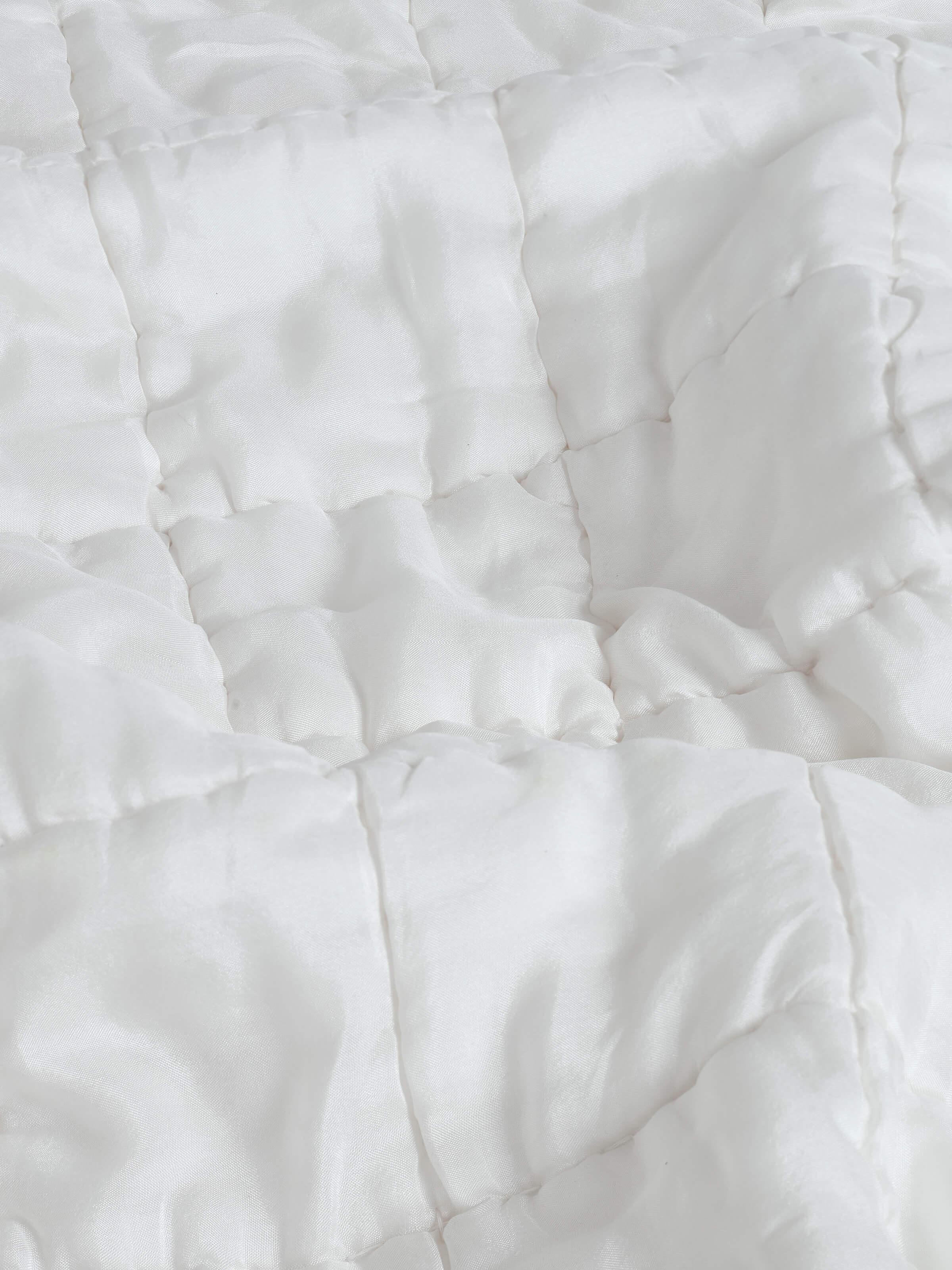 Pipa ivory solid silk razai embroidered double bedspread set (3 pcs) shown in a setting, highlighting its luxurious appearance.