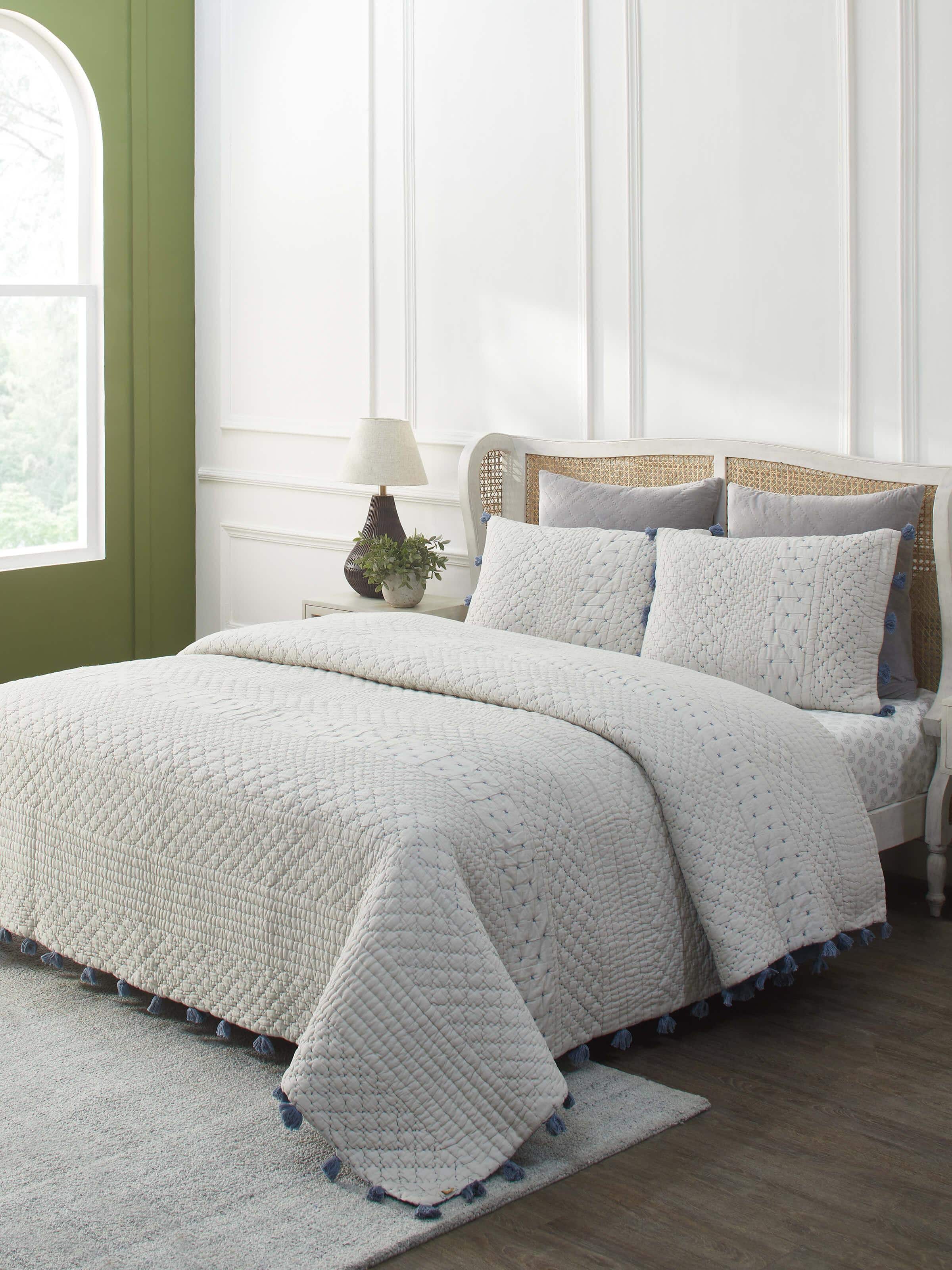 Lifestyle image of Nitya Blue Textured Stripe Cotton Razai Embroidered Double Bedspread Set in a bedroom setting.