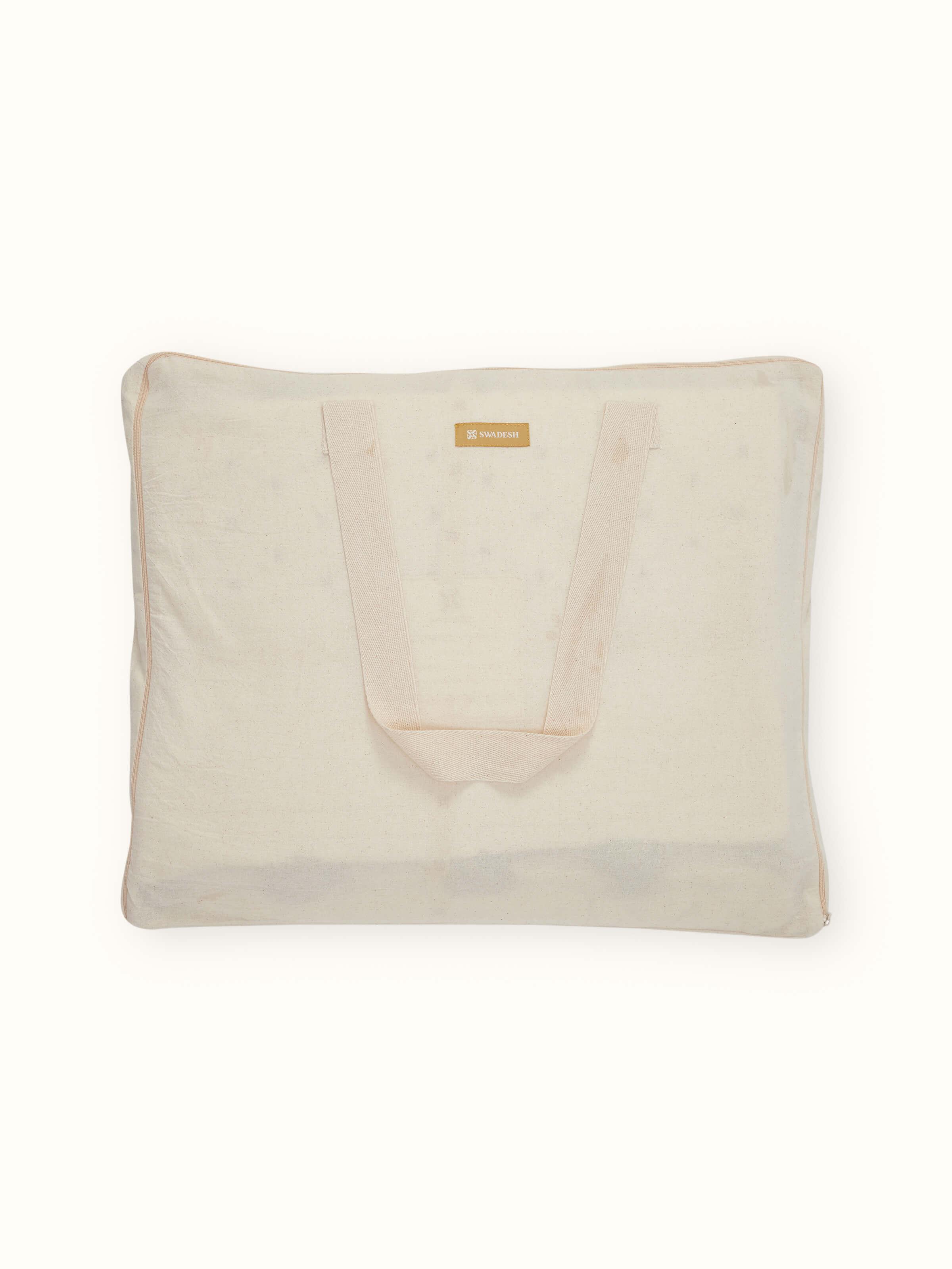 Side view of Nitya off-white textured stripe cotton razai embroidered double bedspread set showcasing the bedspread's thickness and pattern