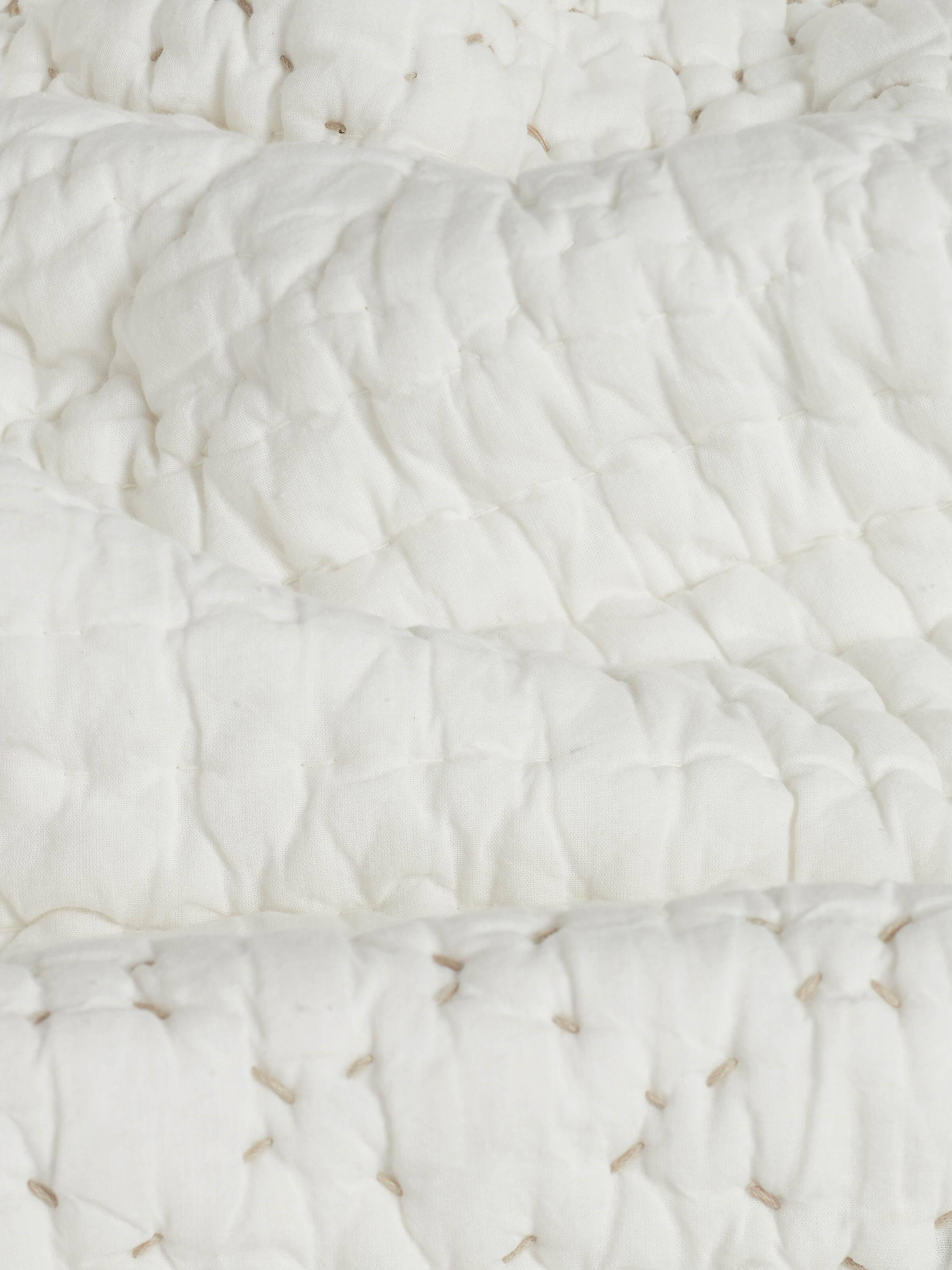 Close-up of Nitya off-white textured stripe cotton razai embroidered double bedspread set focusing on the embroidery and fabric texture