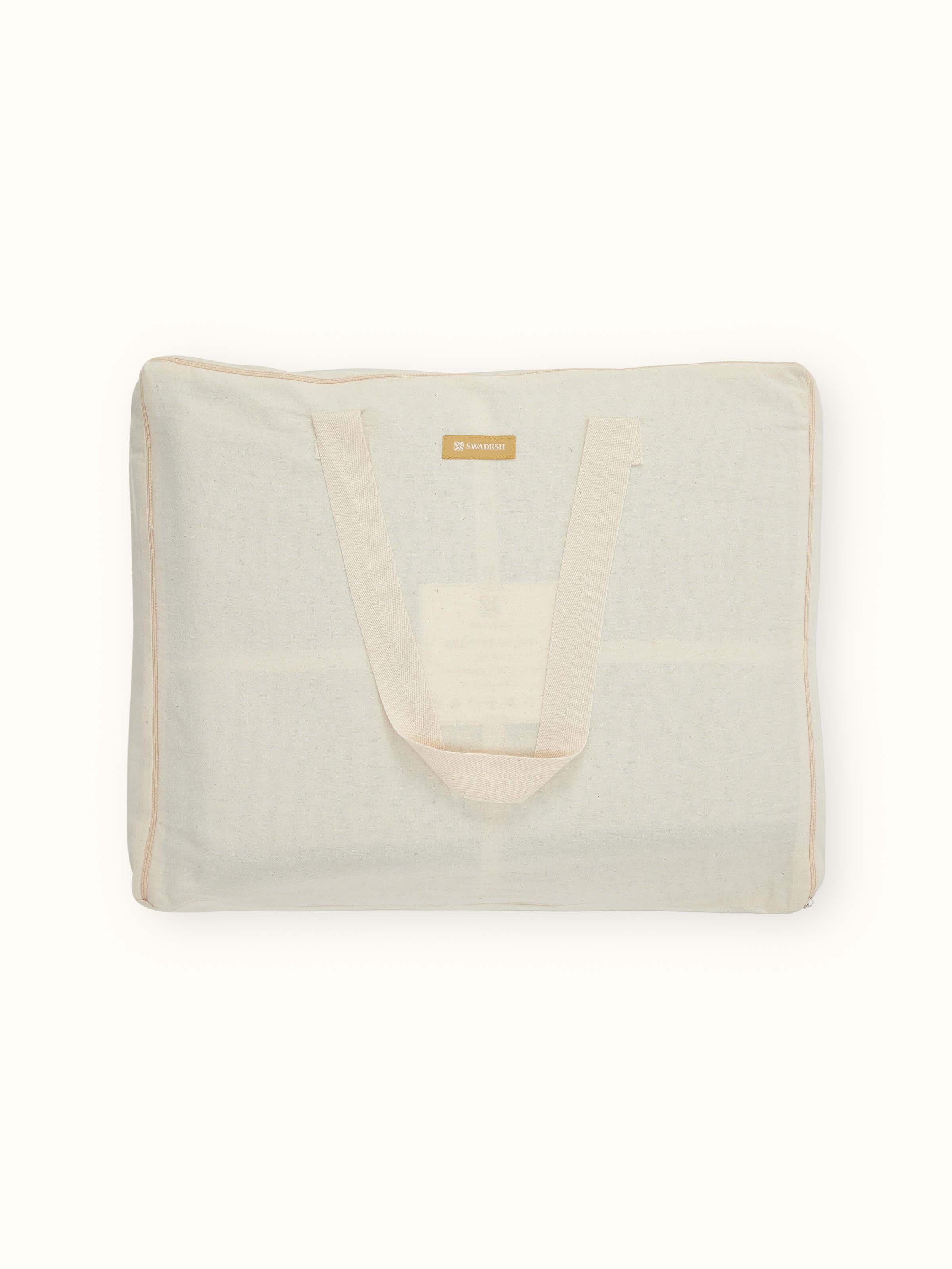 Detailed shot of the embroidery work on a beige two-tone textured cotton razai bedspread, capturing the intricate patterns.