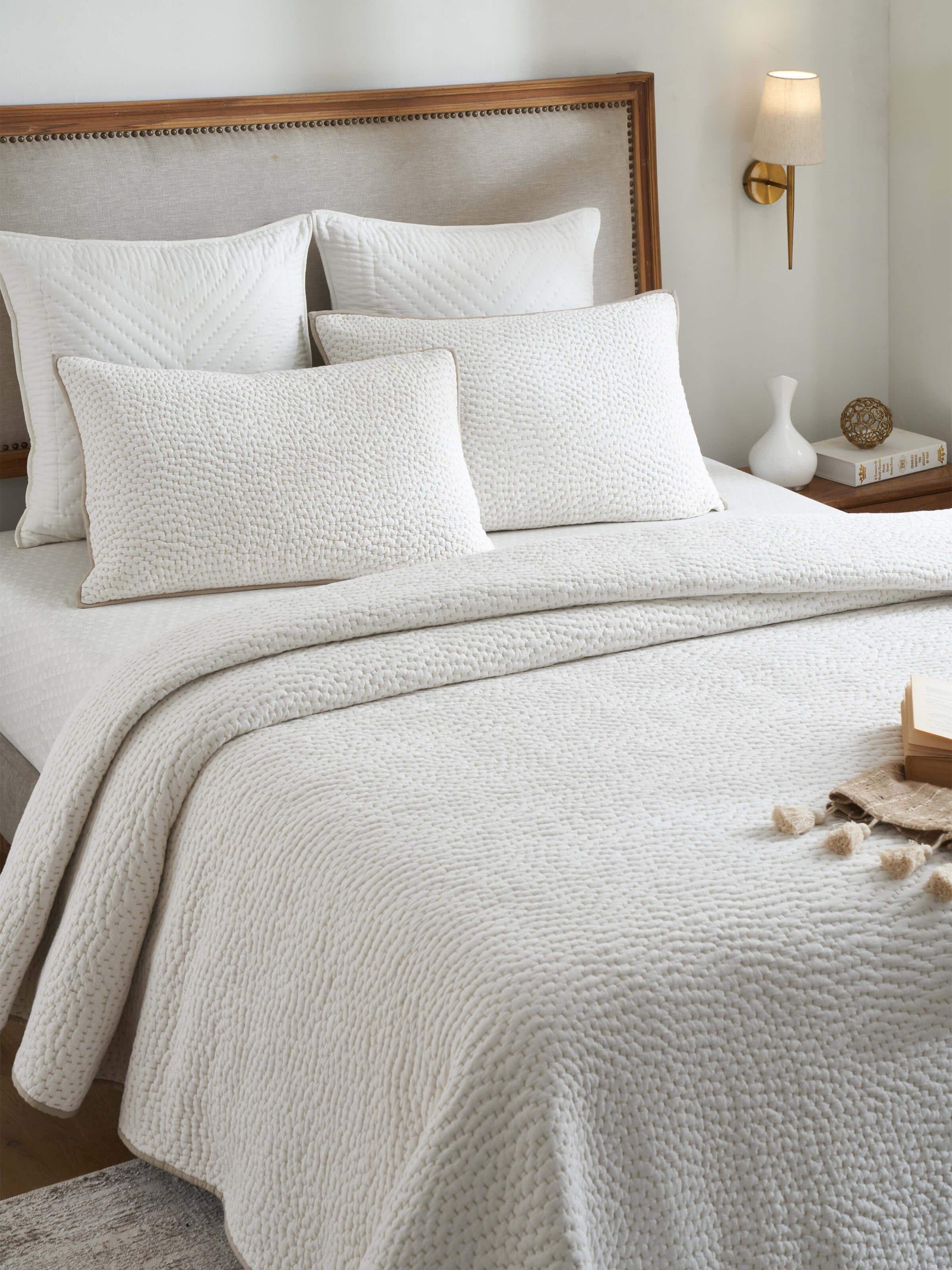 Side view of Nityam Ivory Two-Tone Textured Cotton Razai Embroidered Double Bedspread Set highlighting embroidery detail.