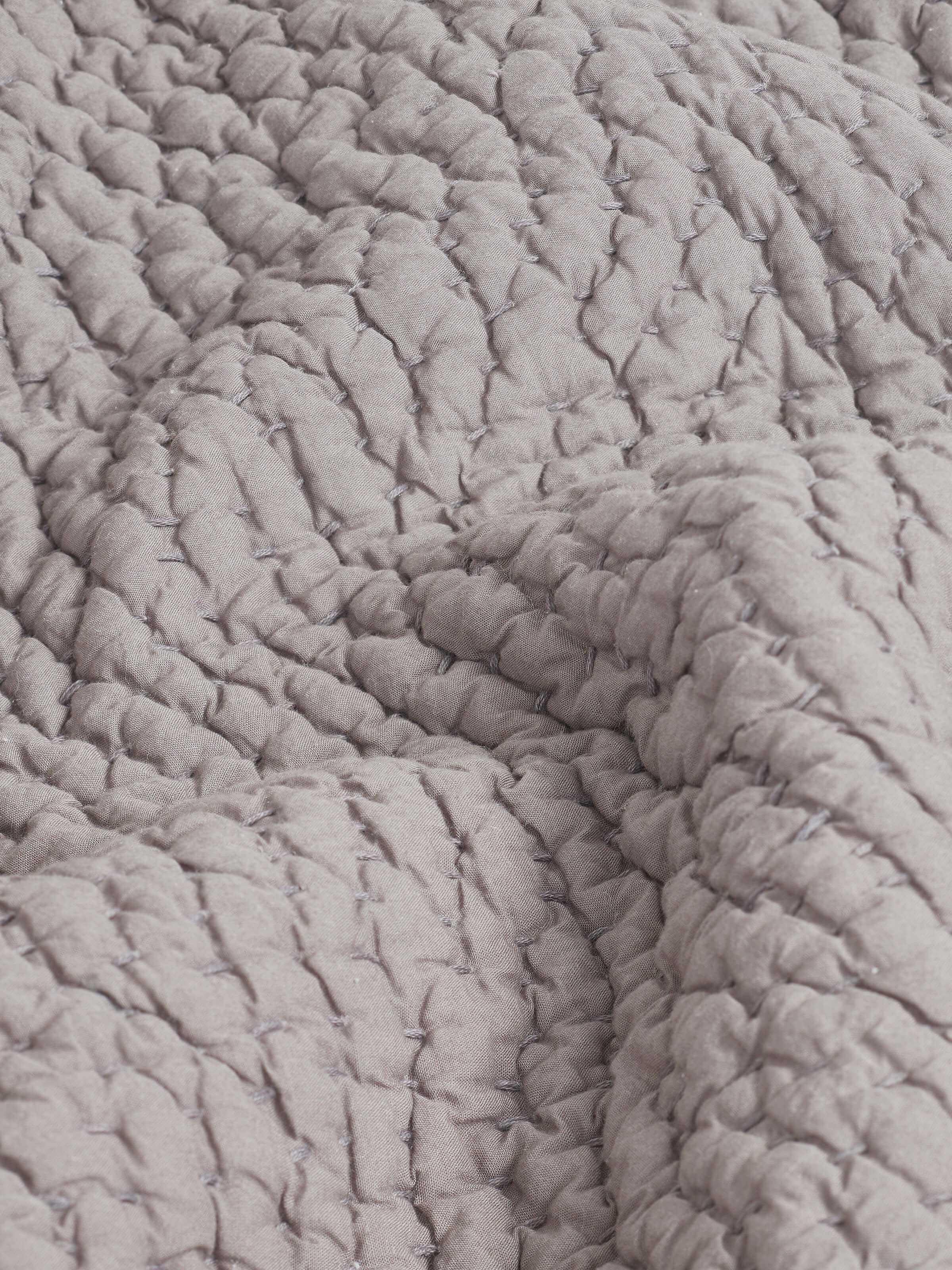 Close-up of Nityam grey textured cotton razai double bedspread set (3 pcs) showcasing intricate embroidery and textured fabric