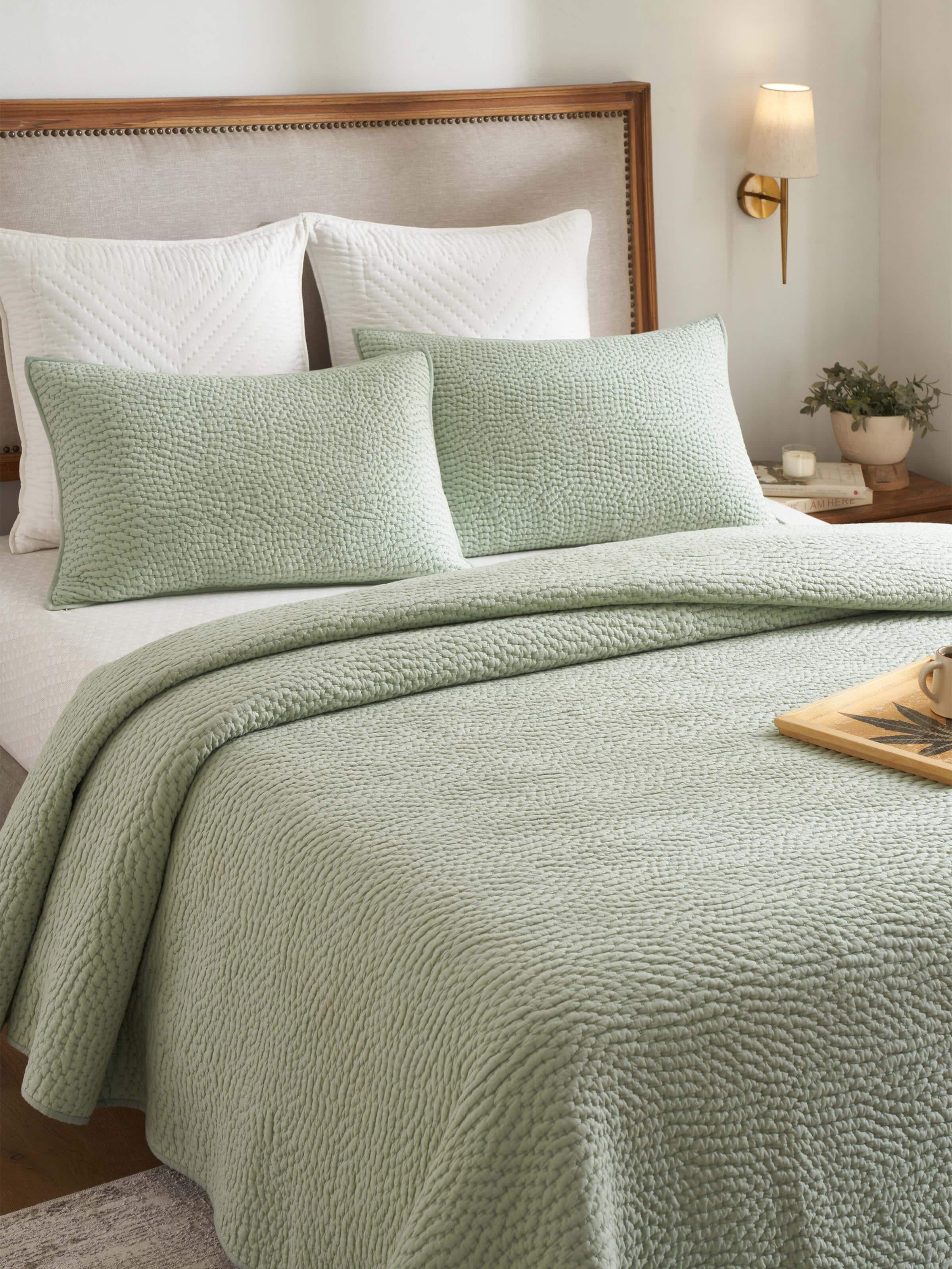 Close-up of Nityam Light Green Two-Tone Textured Cotton Razai Embroidered Double Bedspread Set, highlighting the intricate embroidery and texture.