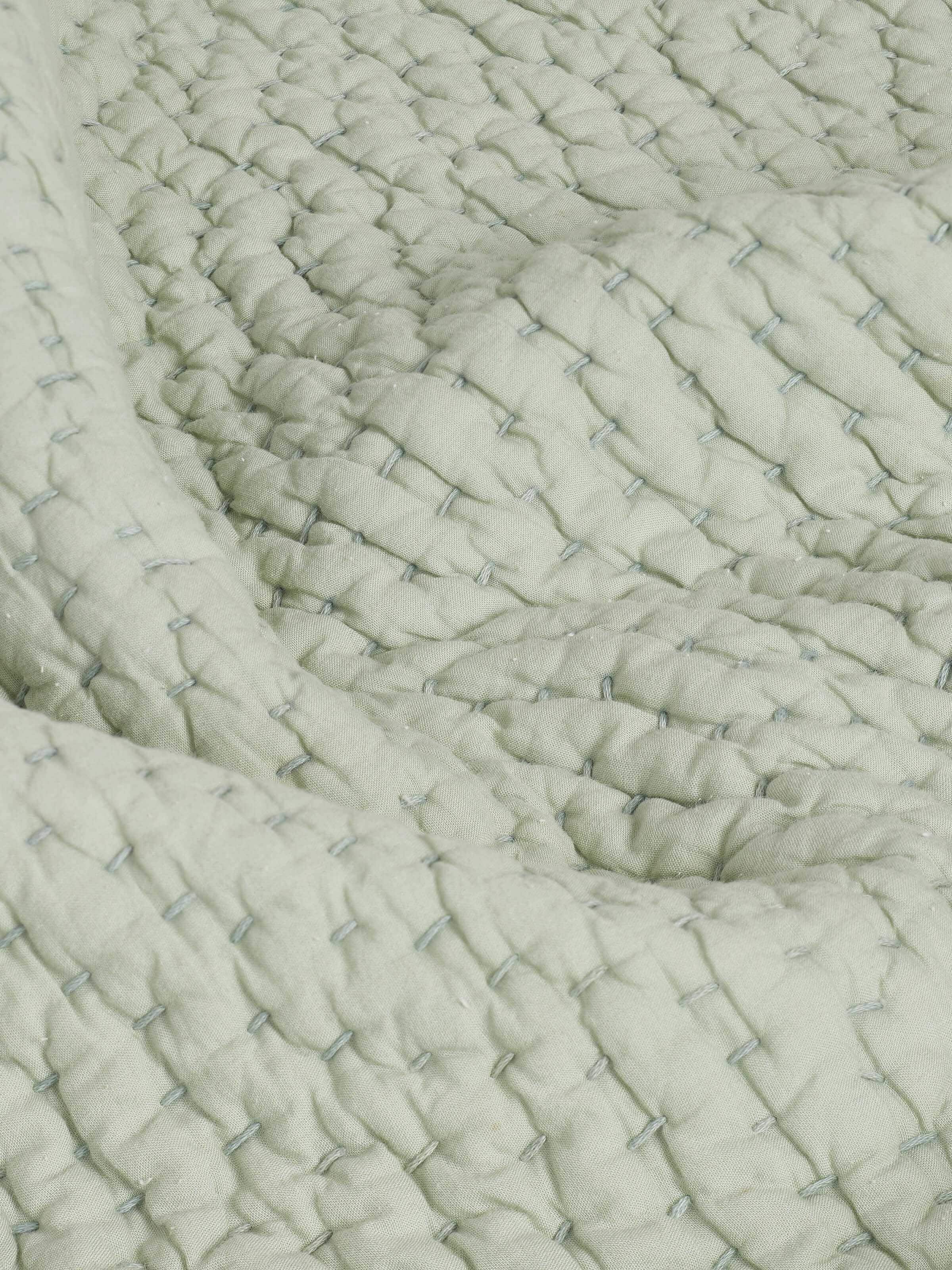 Full view of Nityam Light Green Two-Tone Textured Cotton Razai Embroidered Double Bedspread Set, showing the entire bedspread along with pillow covers.