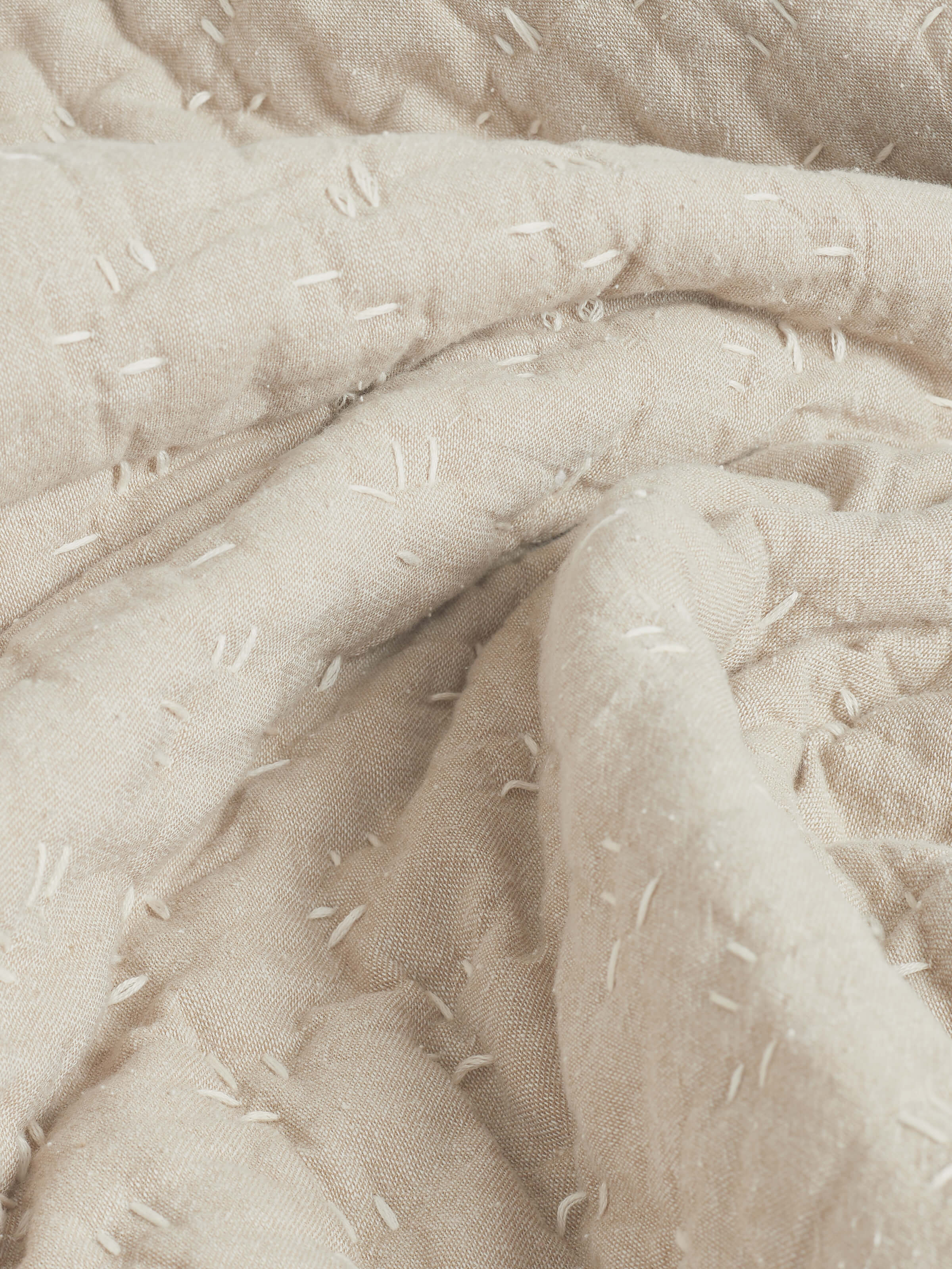 over view of Vaayu beige chambray textured cotton razai embroidered double bedspread set displaying its rich texture