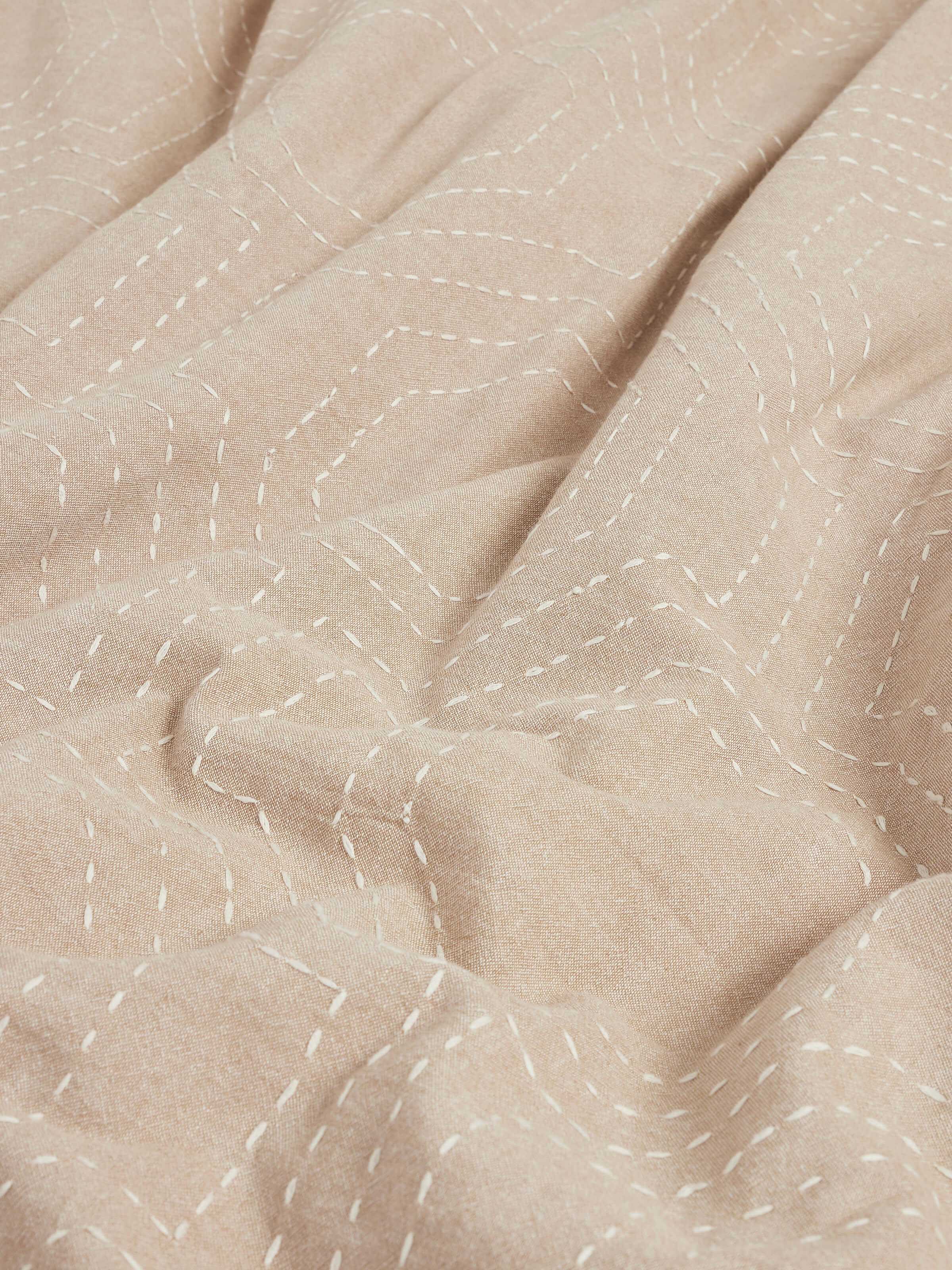 Kahani brown geometric cotton duvet cover arranged to show the Kantha embroidery design and fabric detail.