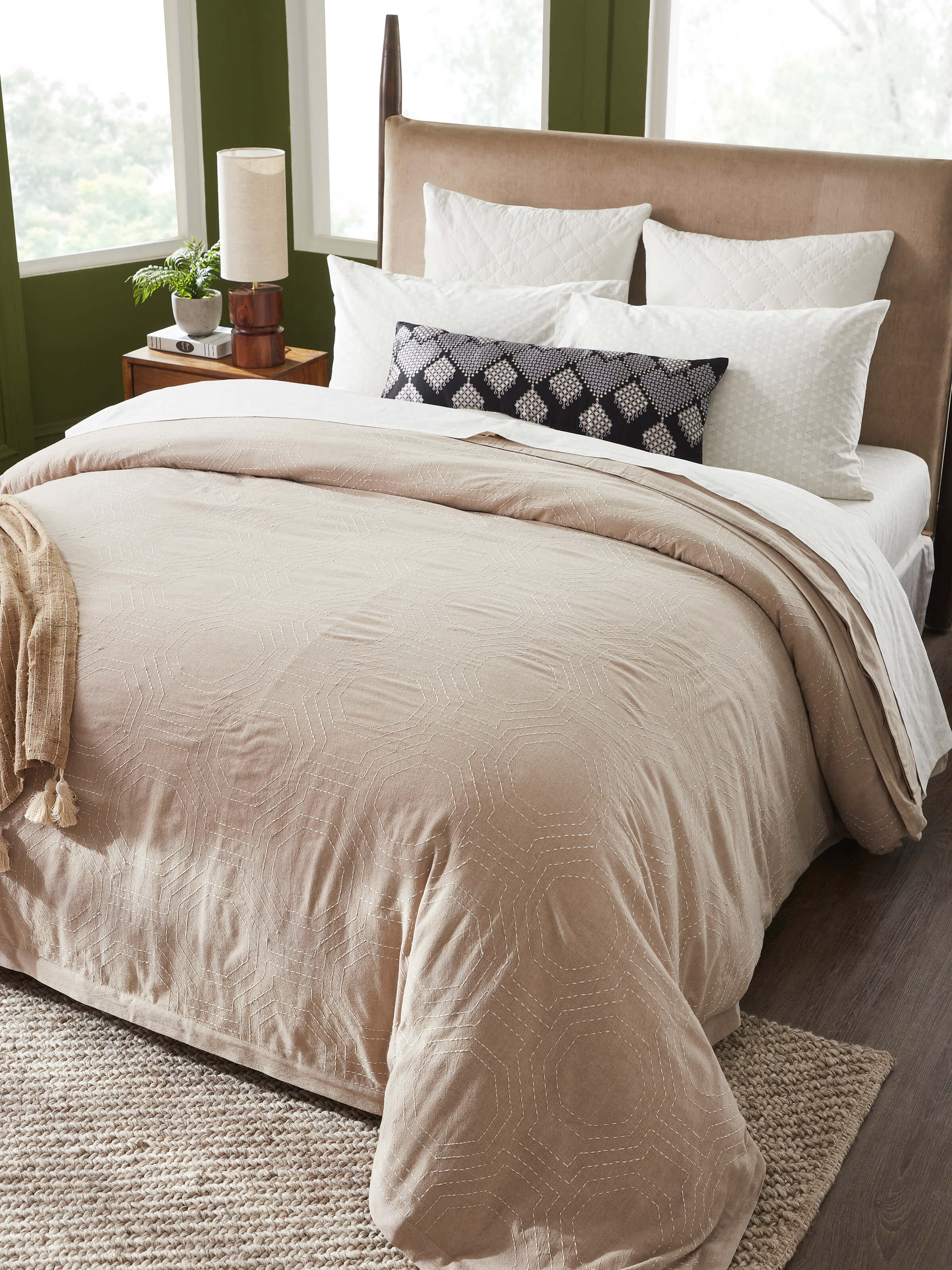 Close-up of Kahani brown geometric cotton duvet cover showing detailed Kantha embroidery and geometric pattern.