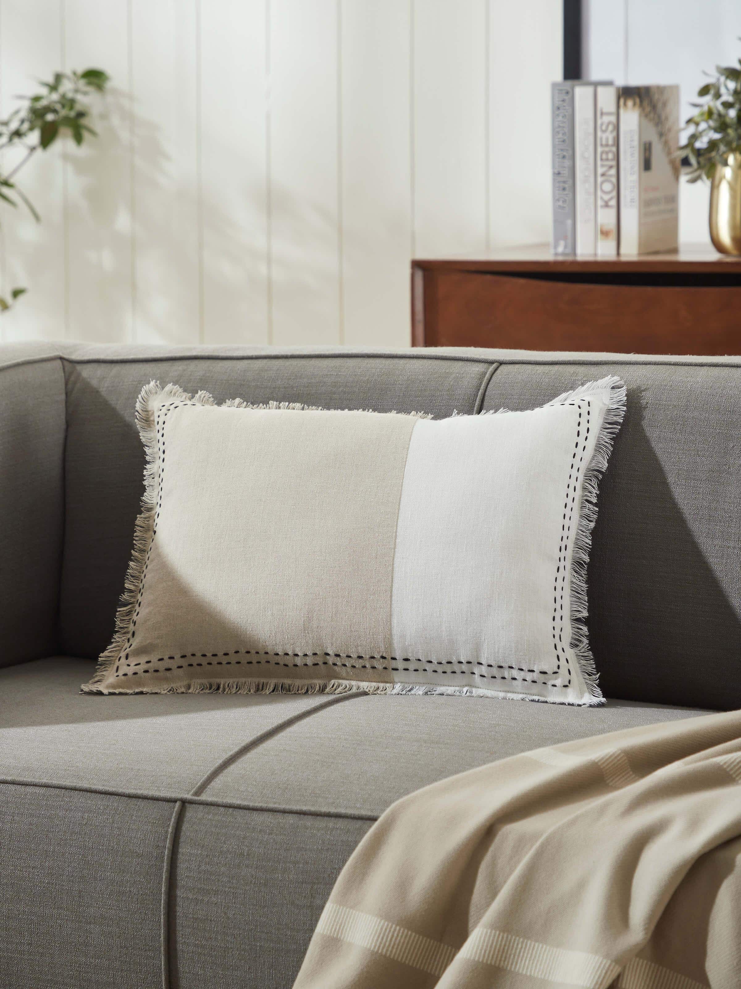 Side view of Kahani beige two tone linen kantha hand embroidery cushion cover highlighting the fabric's texture