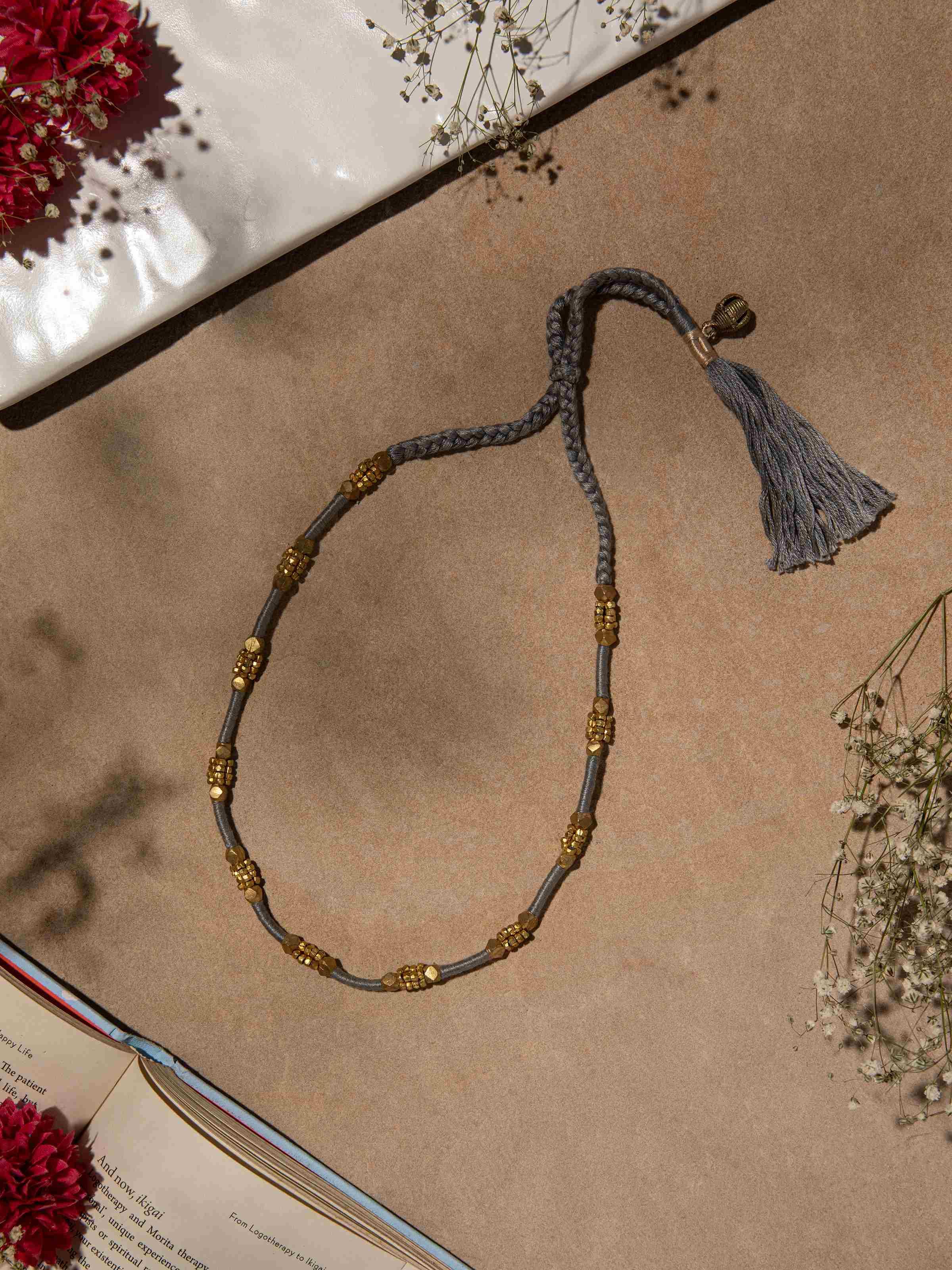 Side view of Dhokra long necklace highlighting intricate metal detailing