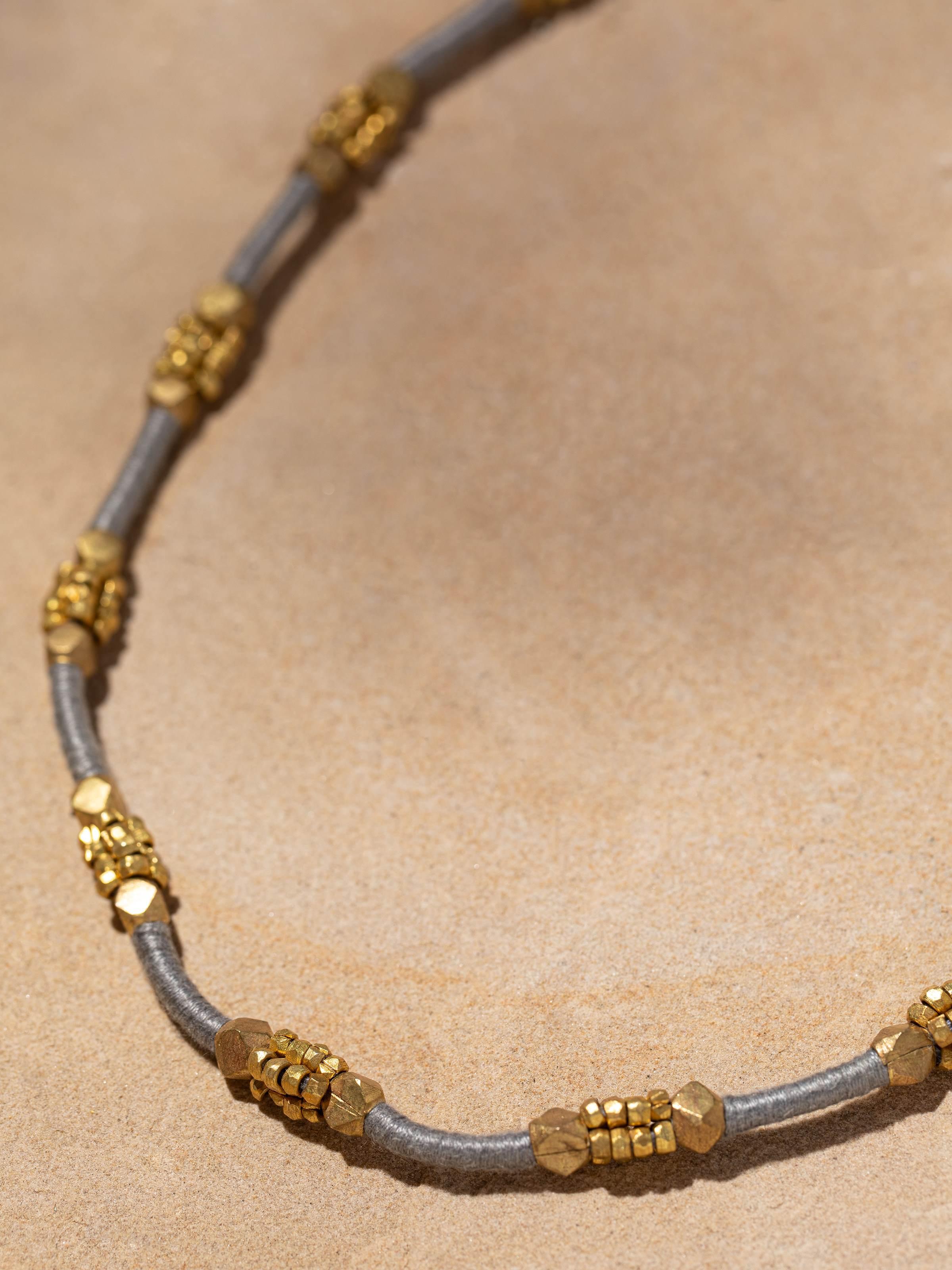 Detailed image of Dhokra long necklace showcasing fine metalwork and traditional design