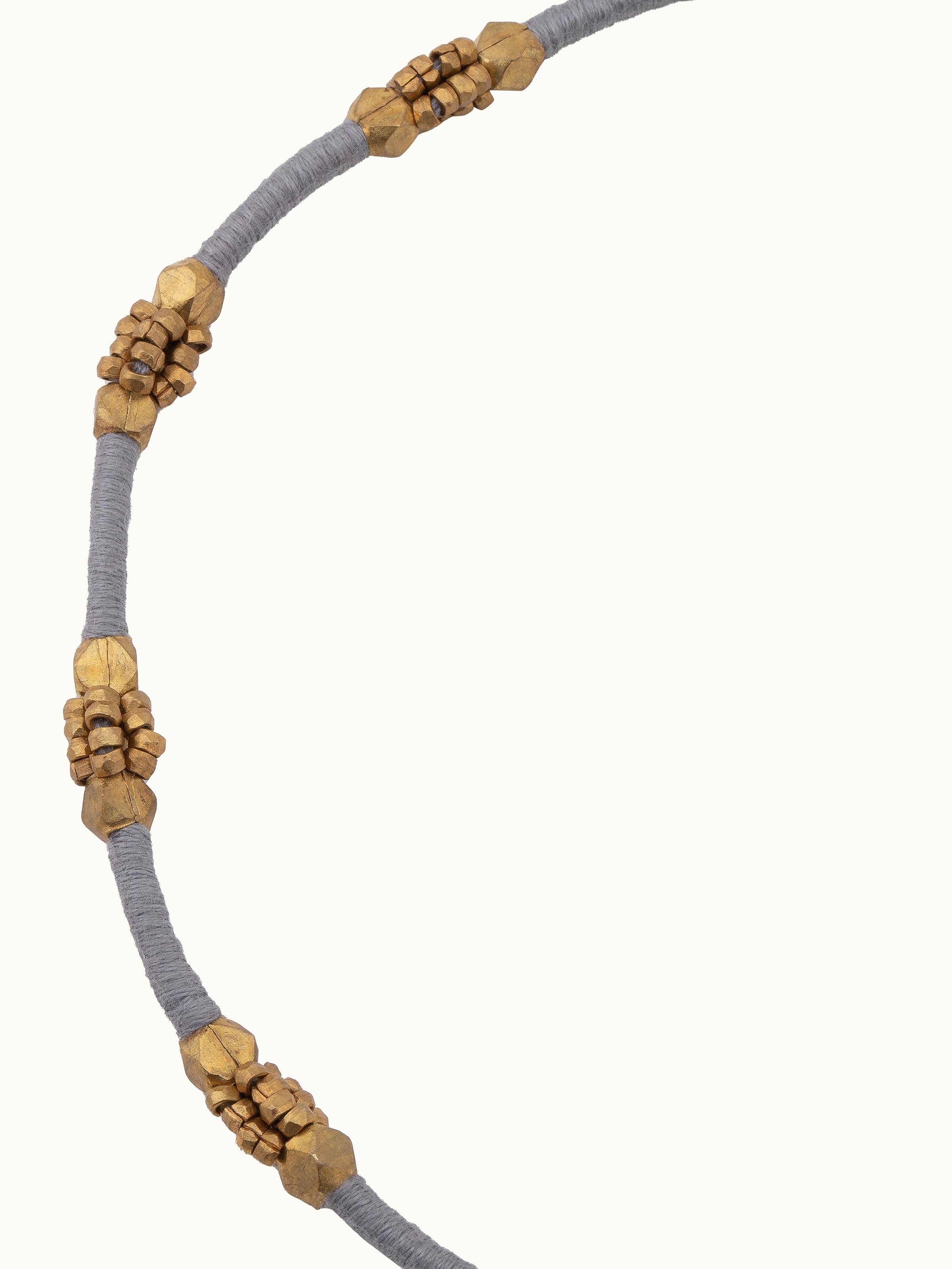Overhead view of Dhokra long necklace highlighting overall length and intricate detailing