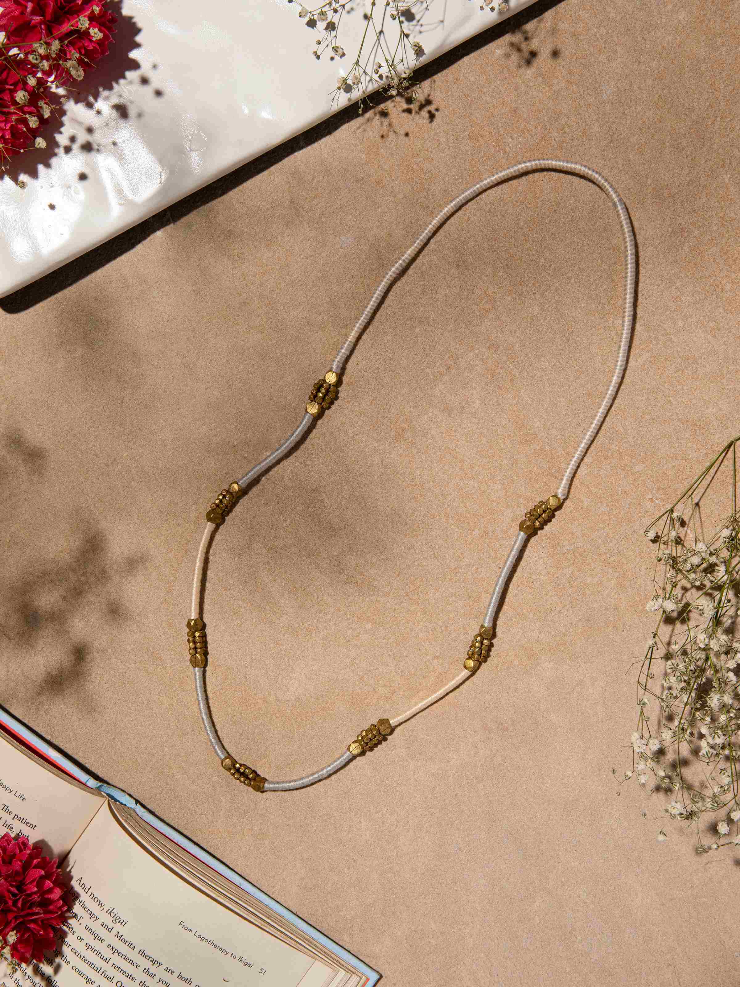 Side view of Dhokra Long Necklace highlighting the long, elegant design and traditional metalwork.