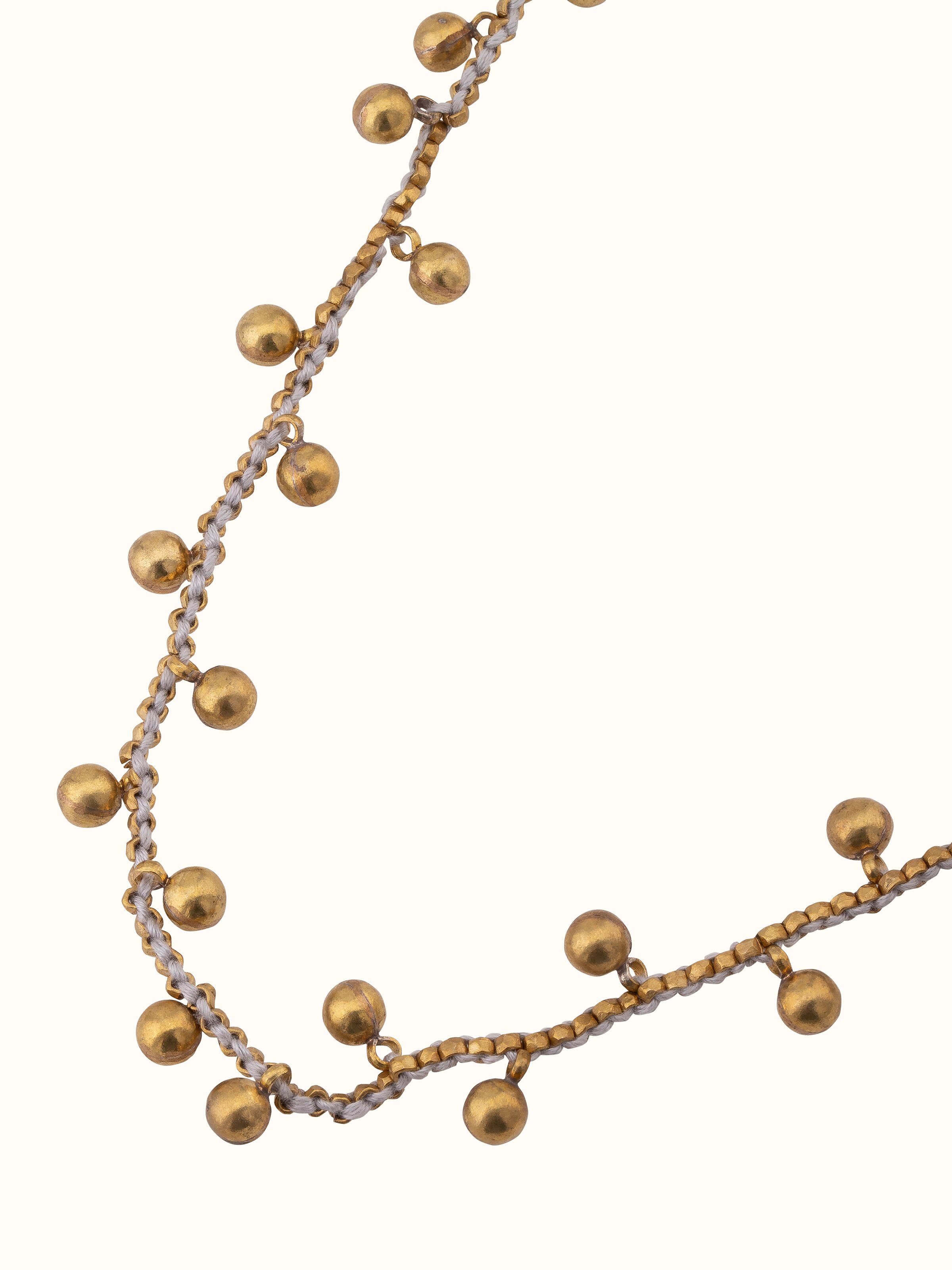 Angled view of Dhokra long necklace showcasing its intricate design and rich detailing