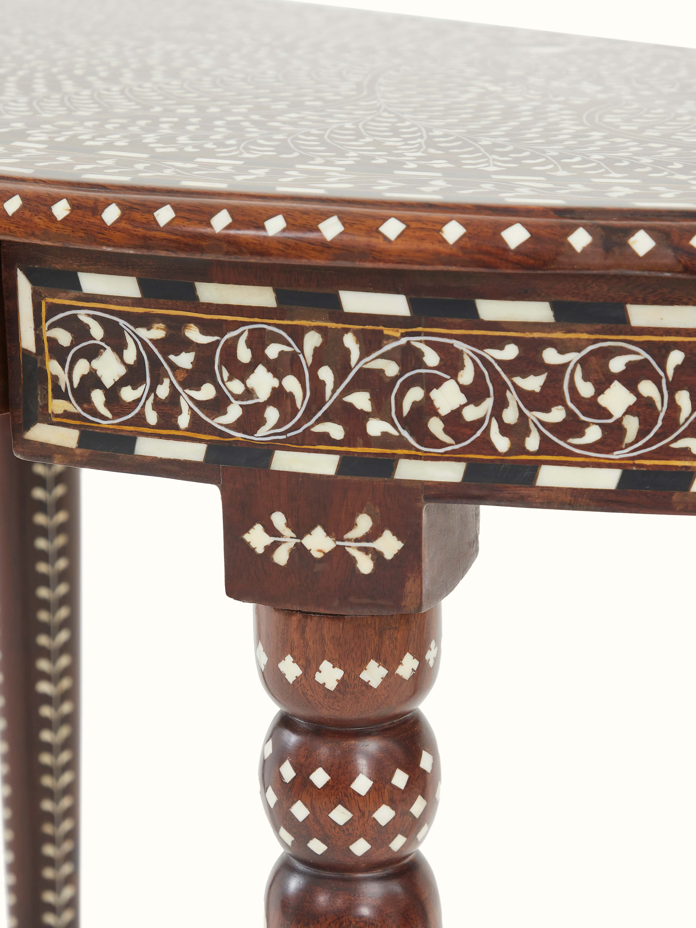 Detailed view of the dressing table’s wood grain and bone inlay work, focusing on the semicircular mirror console