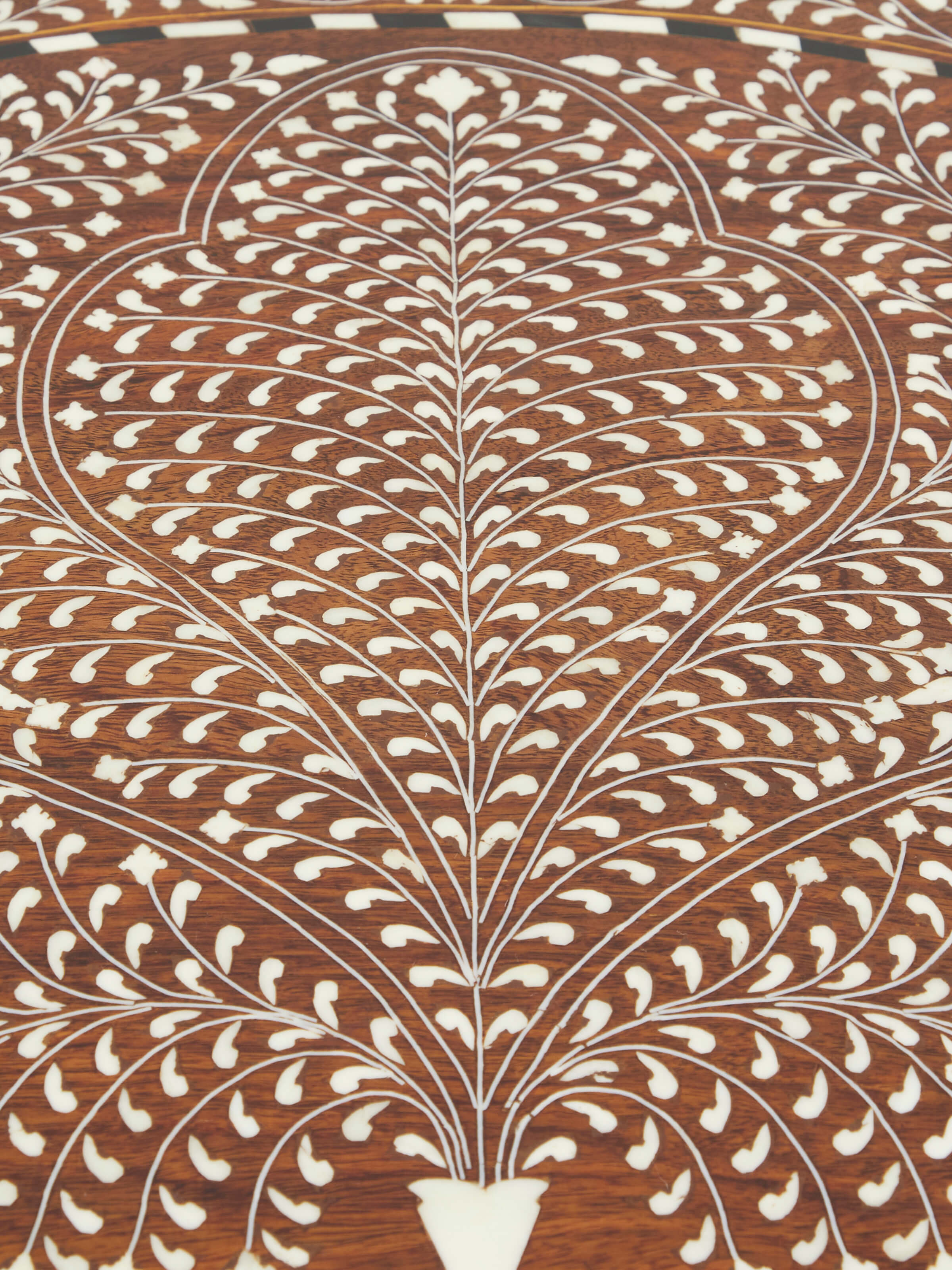 Close-up of the dressing table’s base with Sheesham wood finish and bone inlay accents