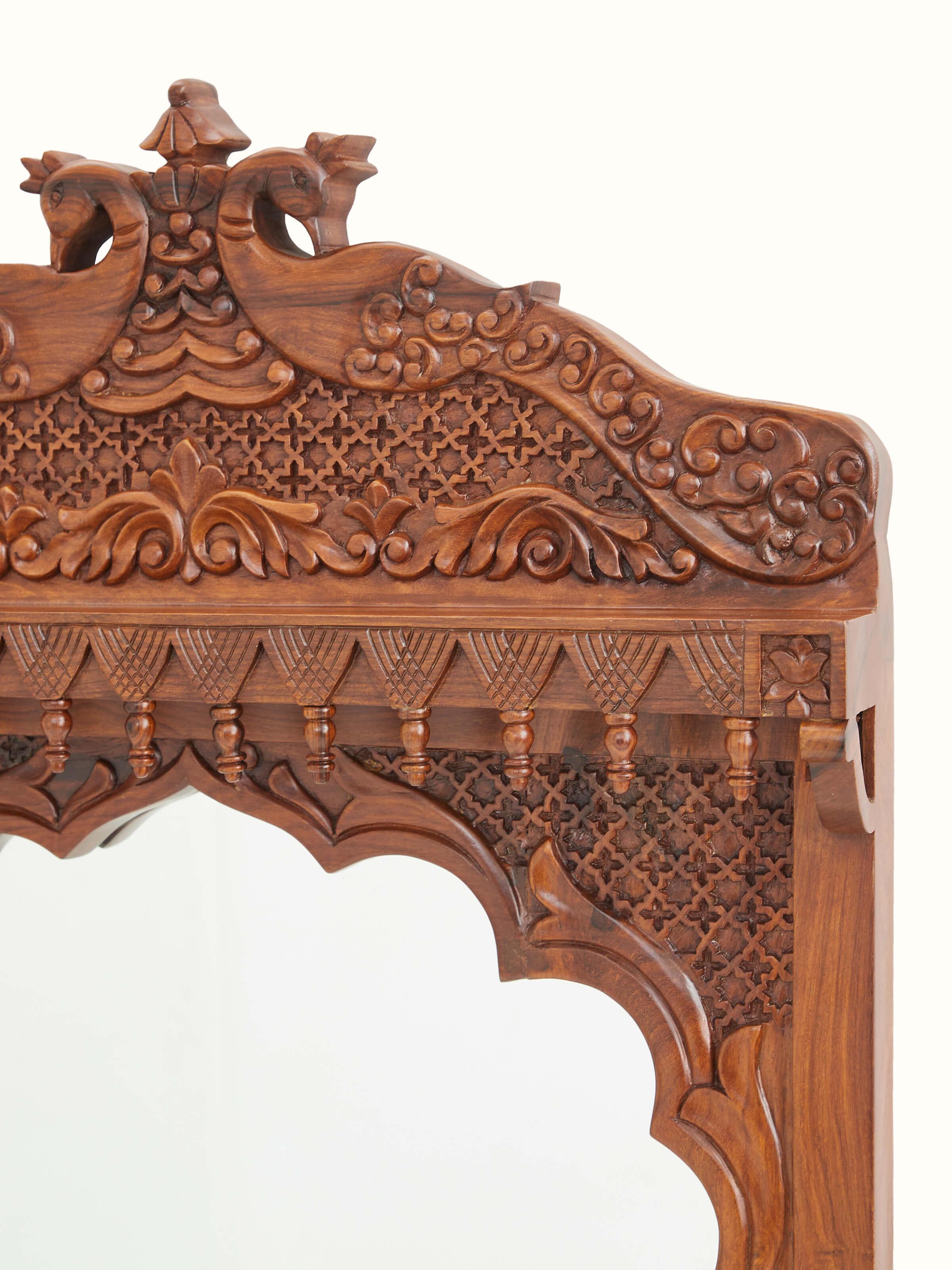 Close-up of the glass mirror and carved frame of the Sheesham wood dressing table