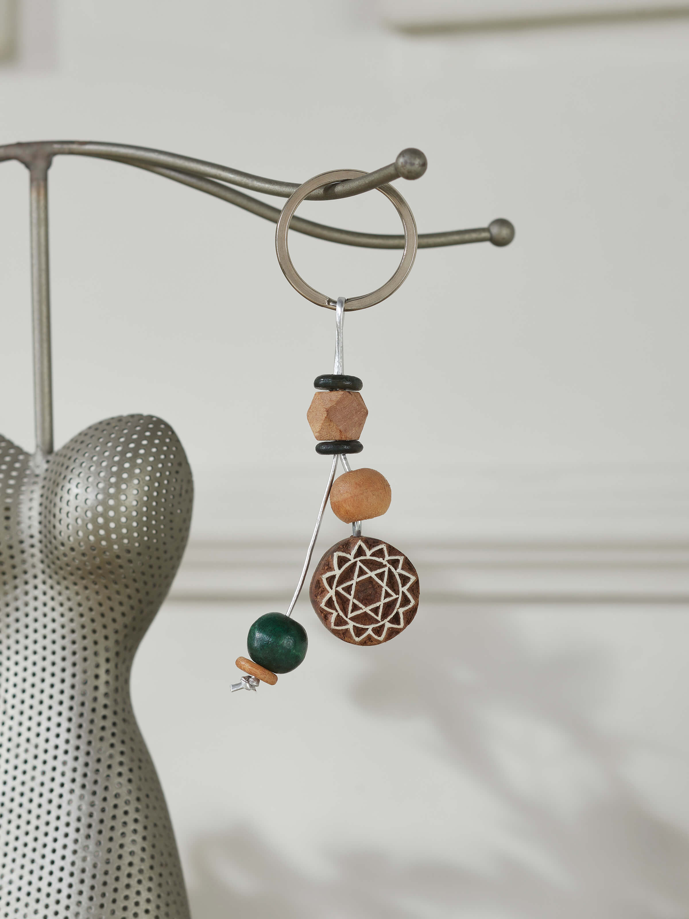 Close-up view of brown block-making wooden keychain, highlighting its texture and design.