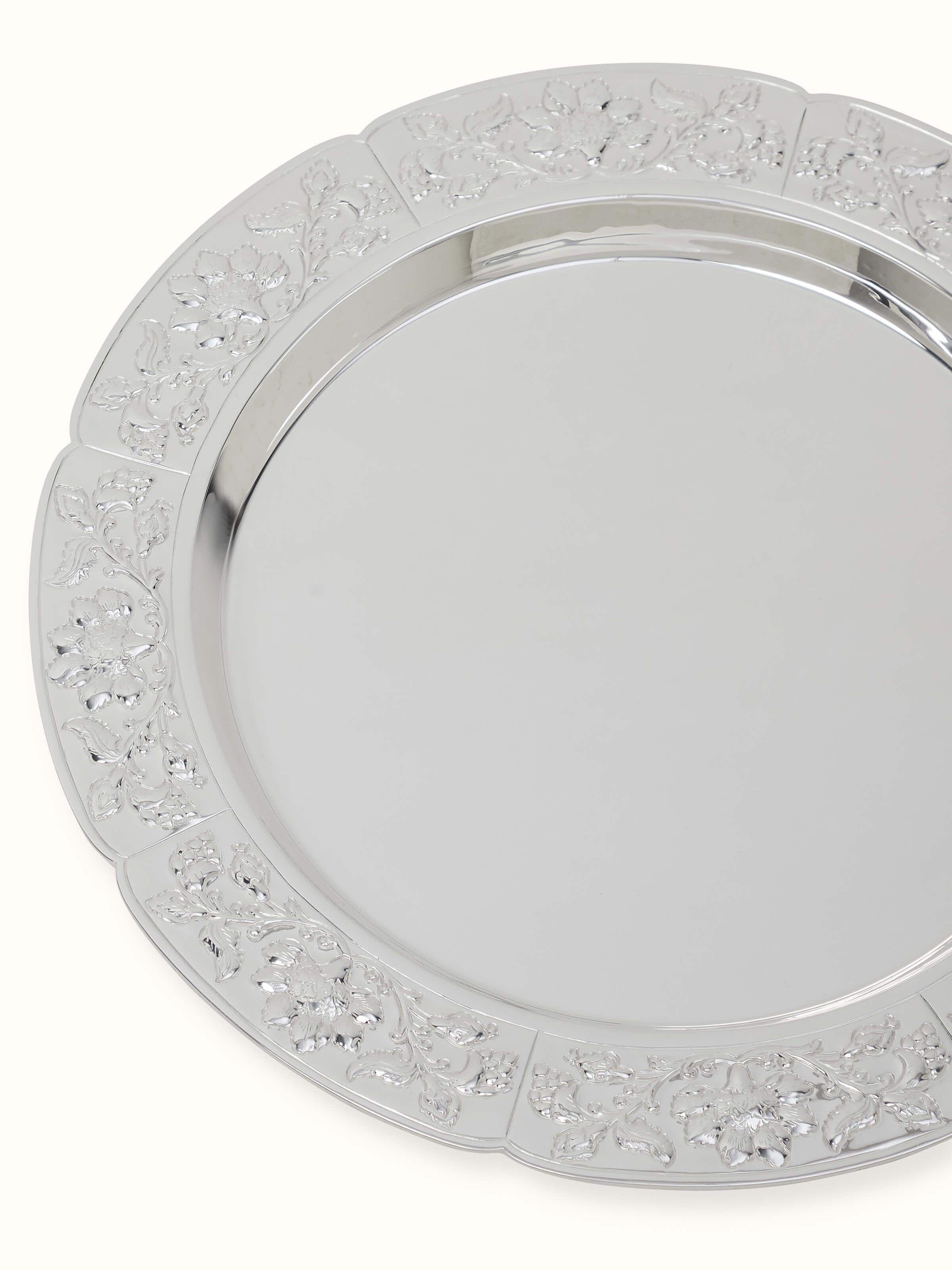 Side view of Kalamkari silver dinner plate highlighting the elegant shape and decorative patterns