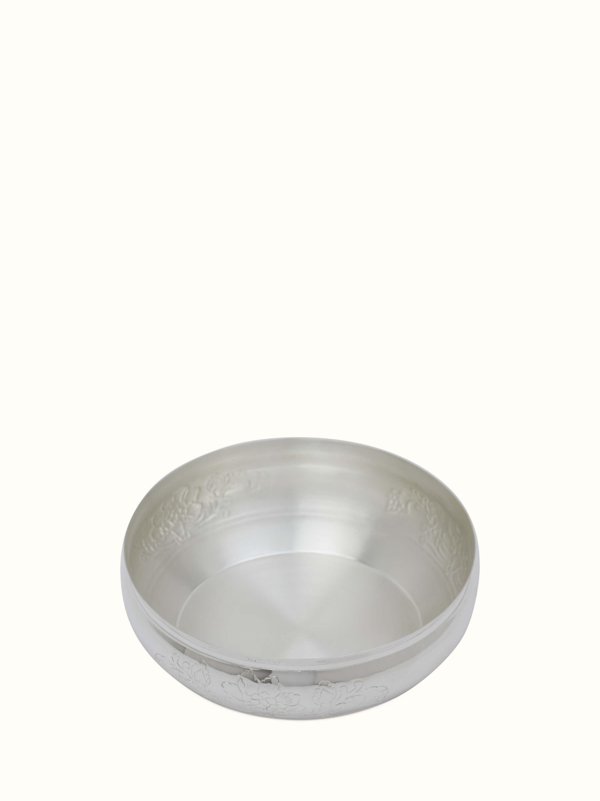 Angled view of Kalamkari silver shallow bowl showcasing detailed designs and elegant silver finish.