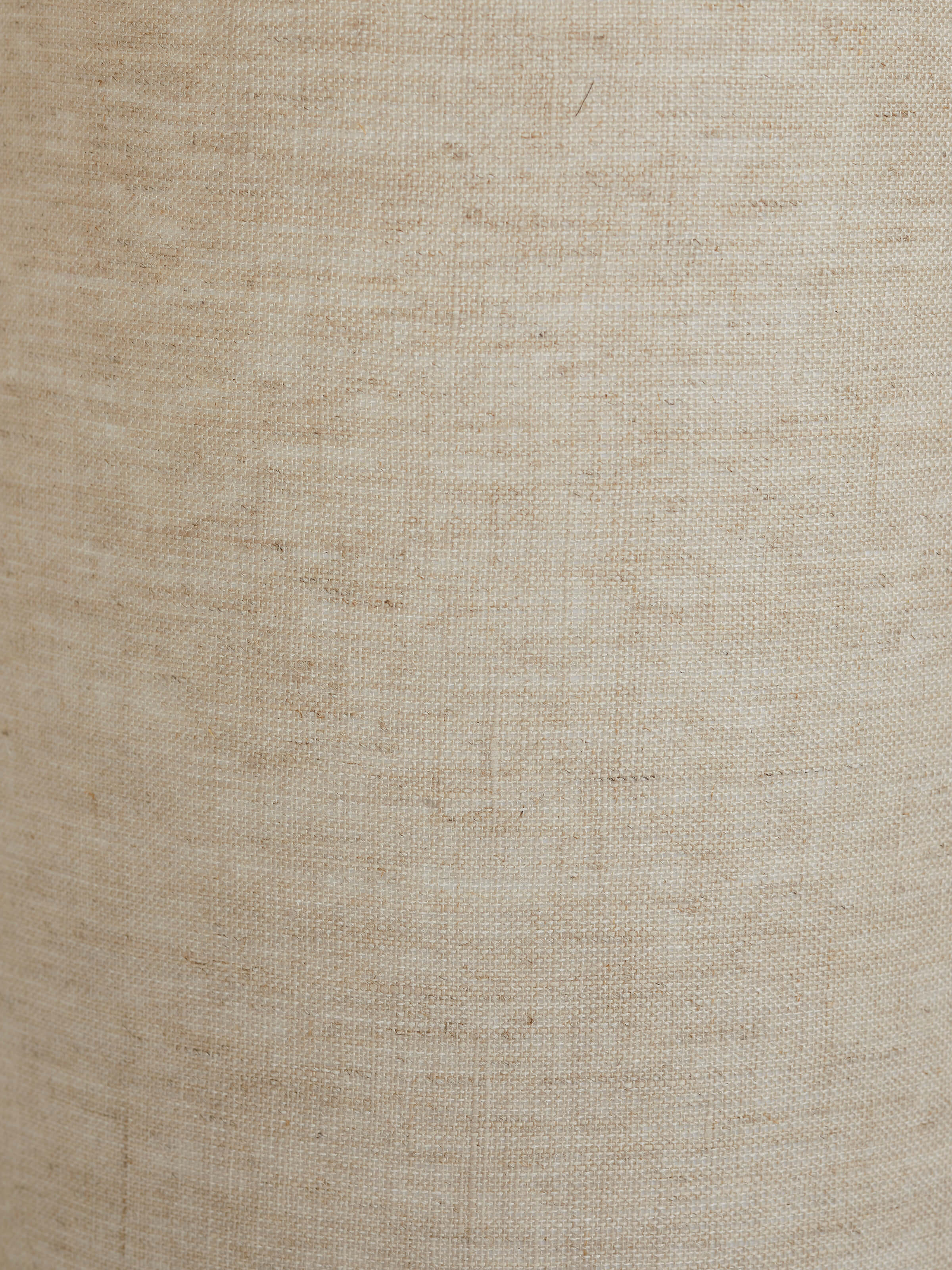 Full view of tall beige wood and cotton fabric table lamp, highlighting the lamp's elegant design and functionality.