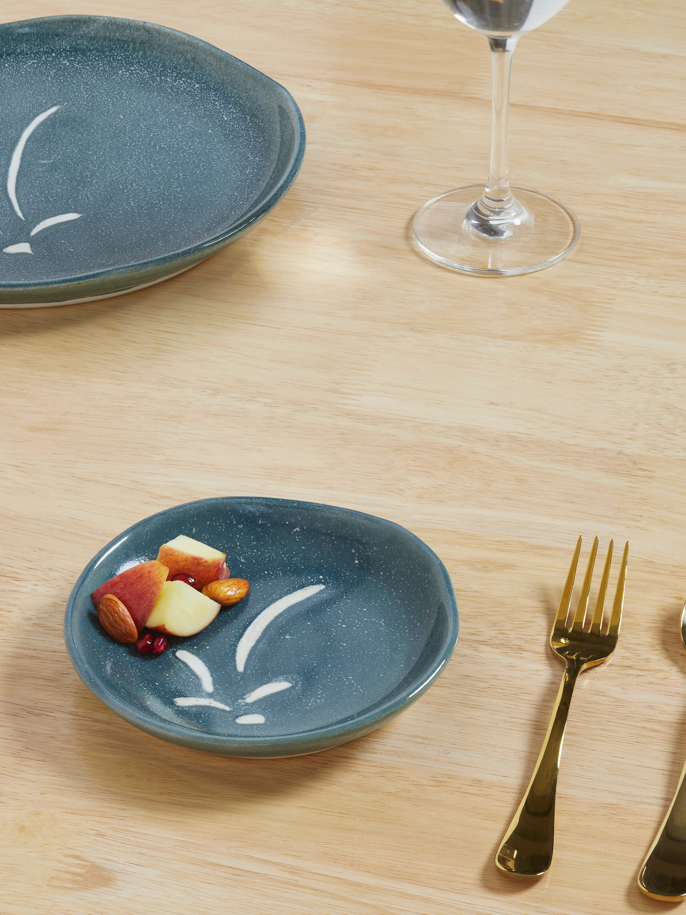 Front view of a grey studio pottery ceramic salad plate, highlighting its sleek design and smooth surface.