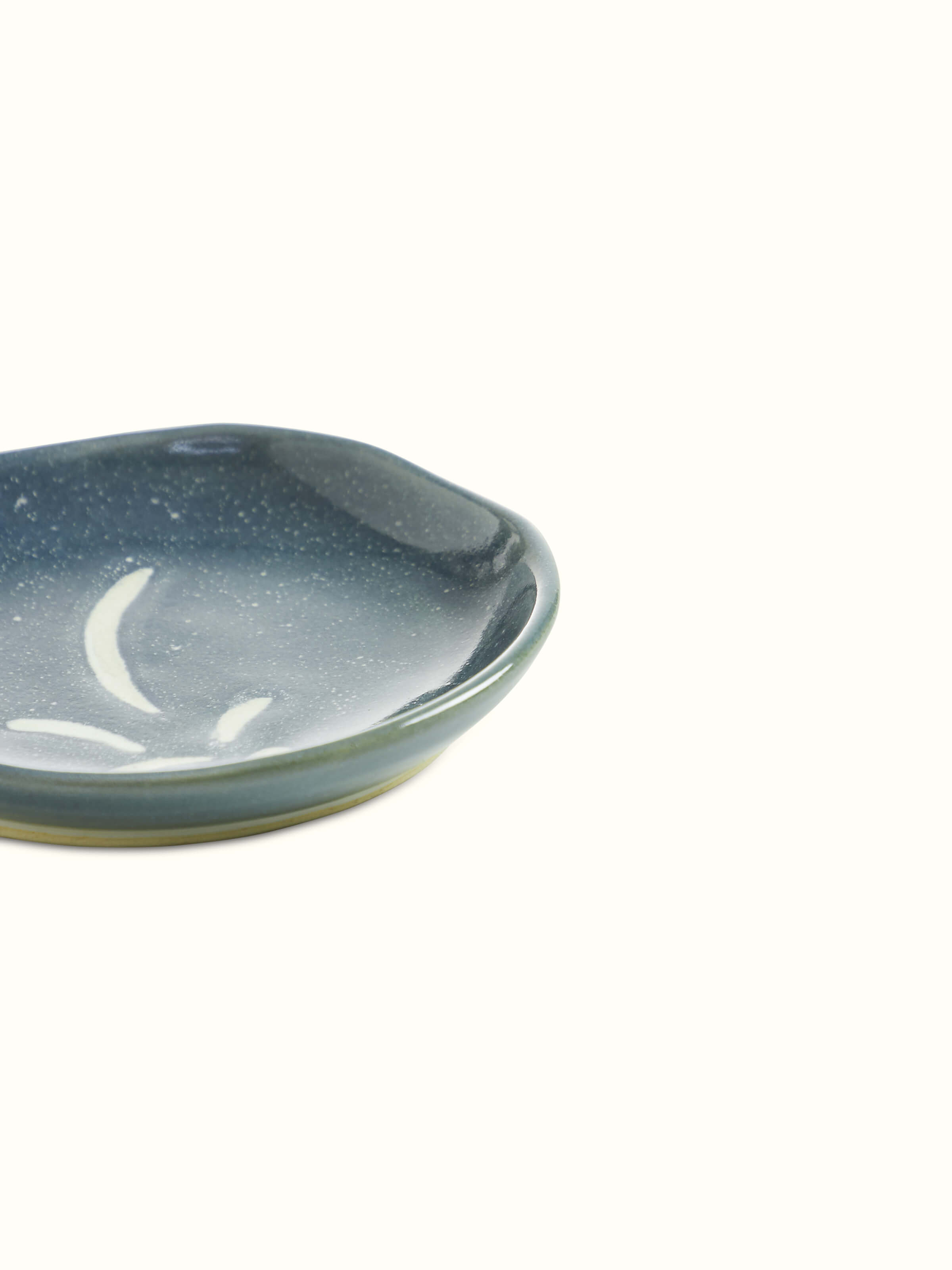 Angled view of a grey studio pottery ceramic salad plate, showcasing its refined edges and elegant form.