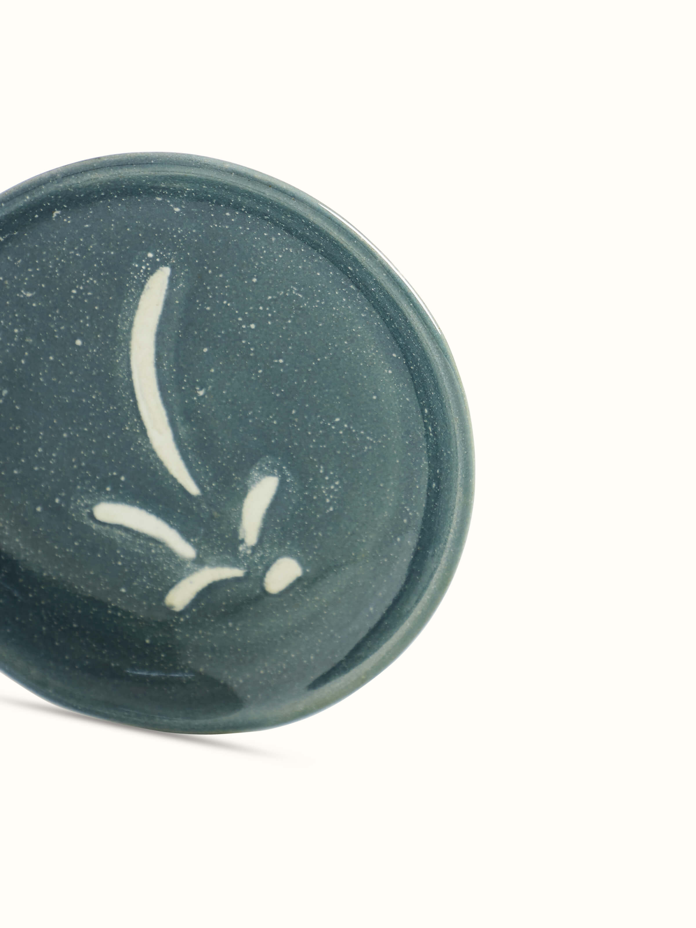 Close-up of a grey studio pottery ceramic salad plate, focusing on its detailed texture and quality finish.