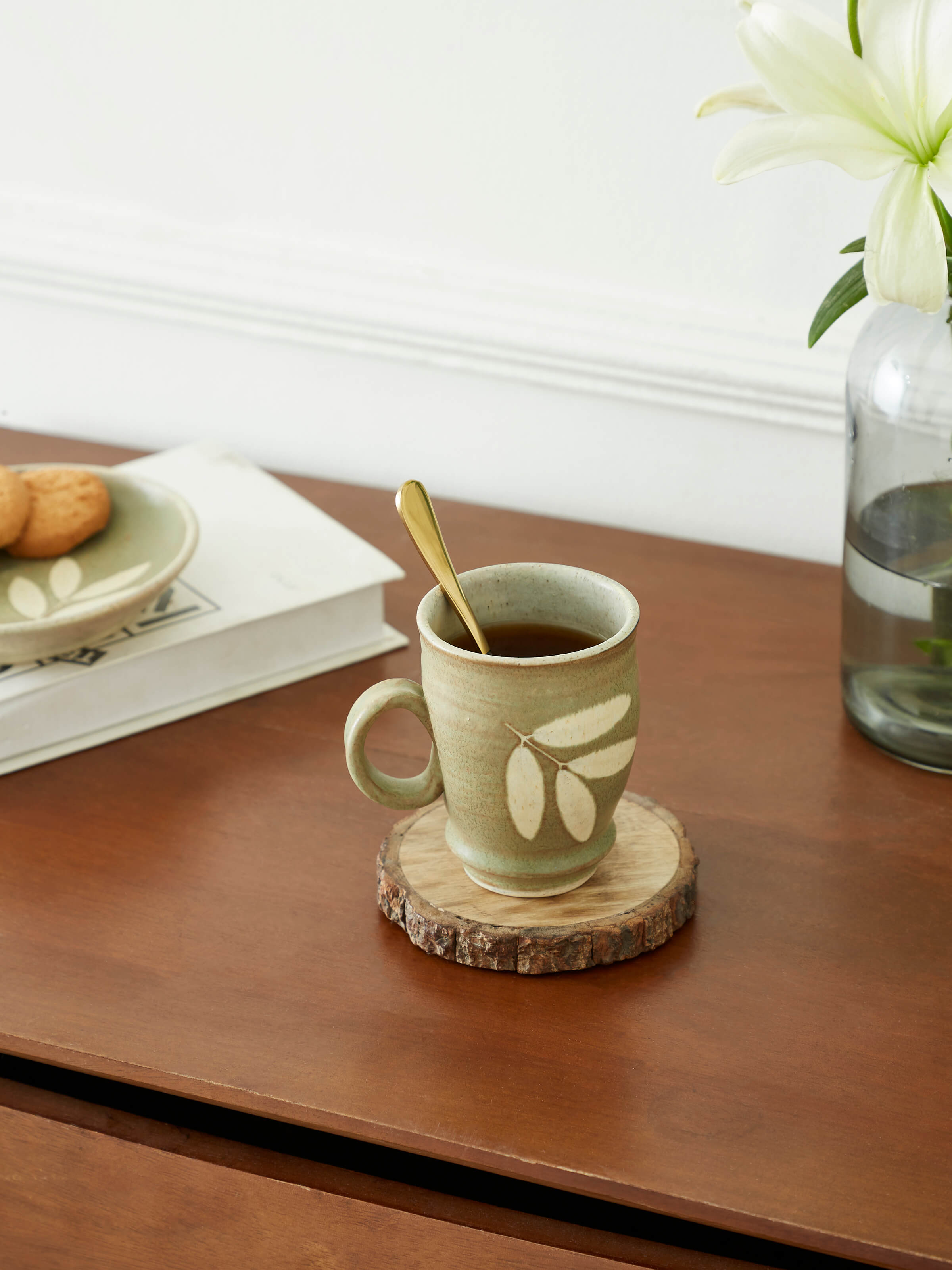 Side view of Studio pottery ceramic coffee mug in olive color showing its smooth finish