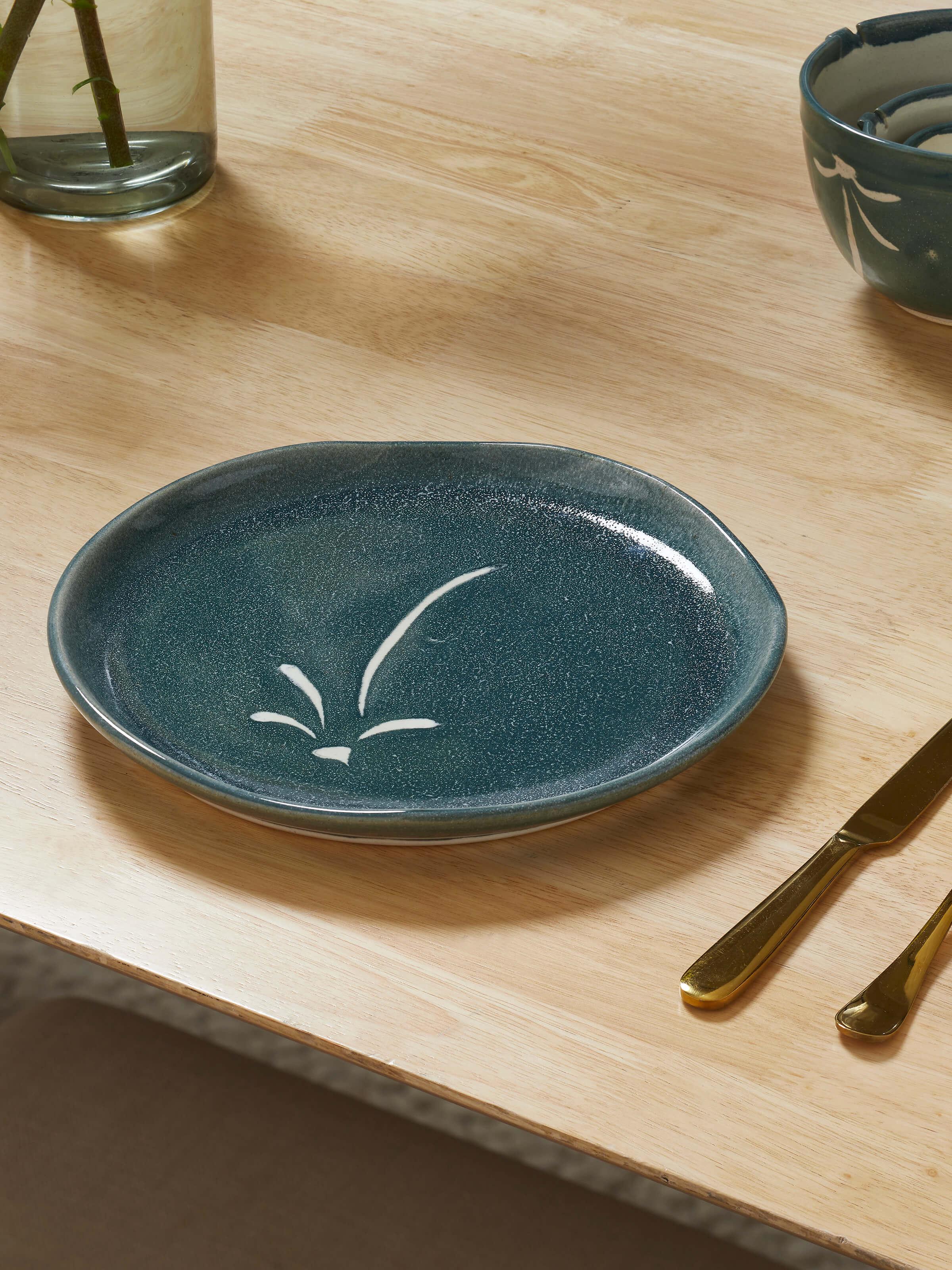 Side view of Studio pottery ceramic dinner plate large highlighting its contemporary shape and clean glaze