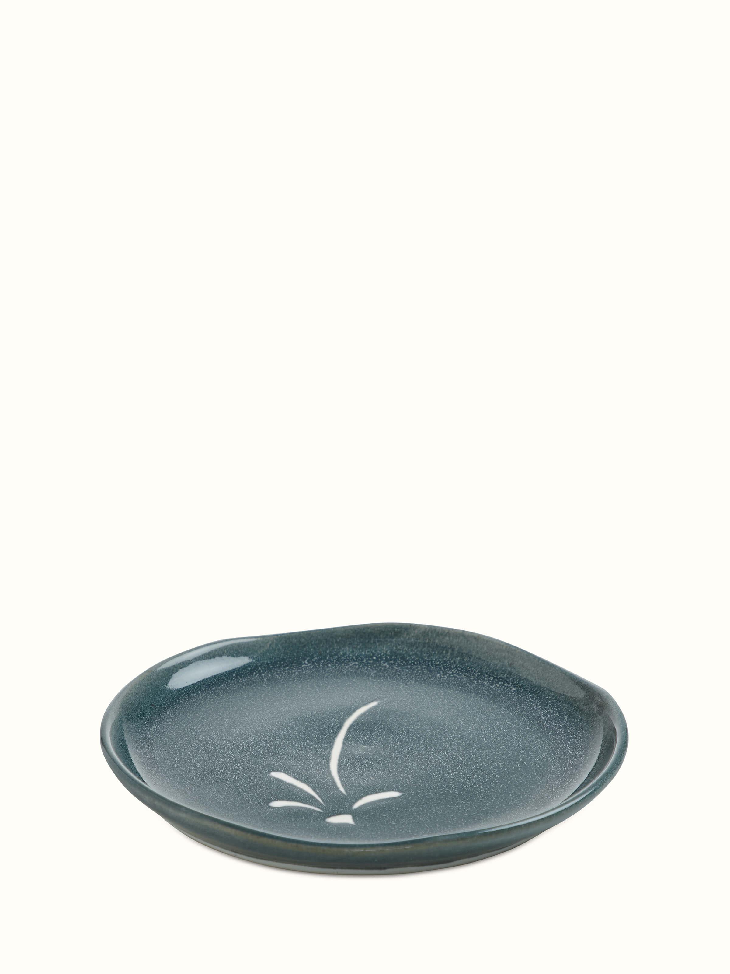 Angled view of Studio pottery ceramic dinner plate large emphasizing the detailed craftsmanship and white ceramic finish