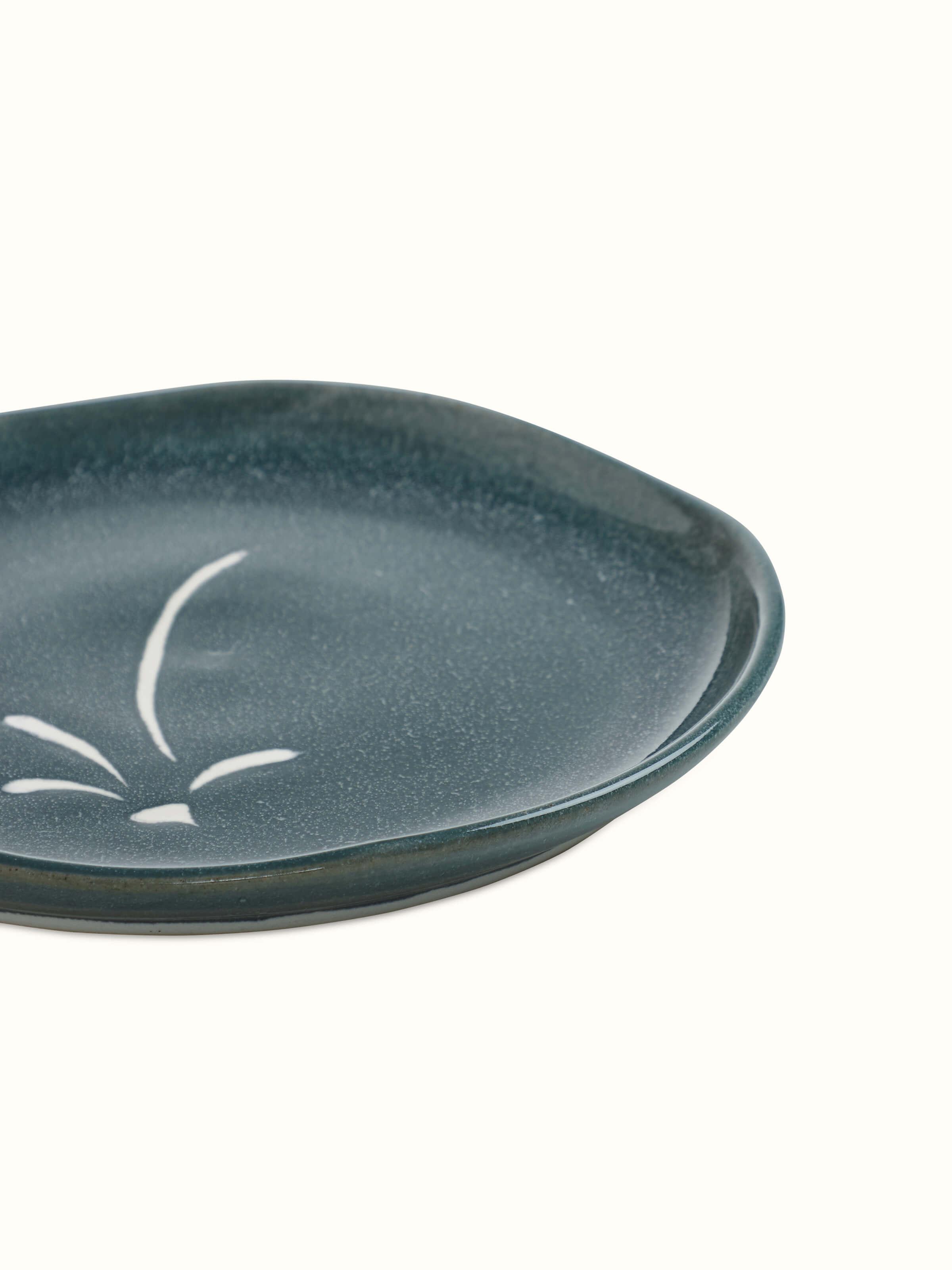 Close-up of Studio pottery ceramic dinner plate large focusing on the smooth texture and elegant design