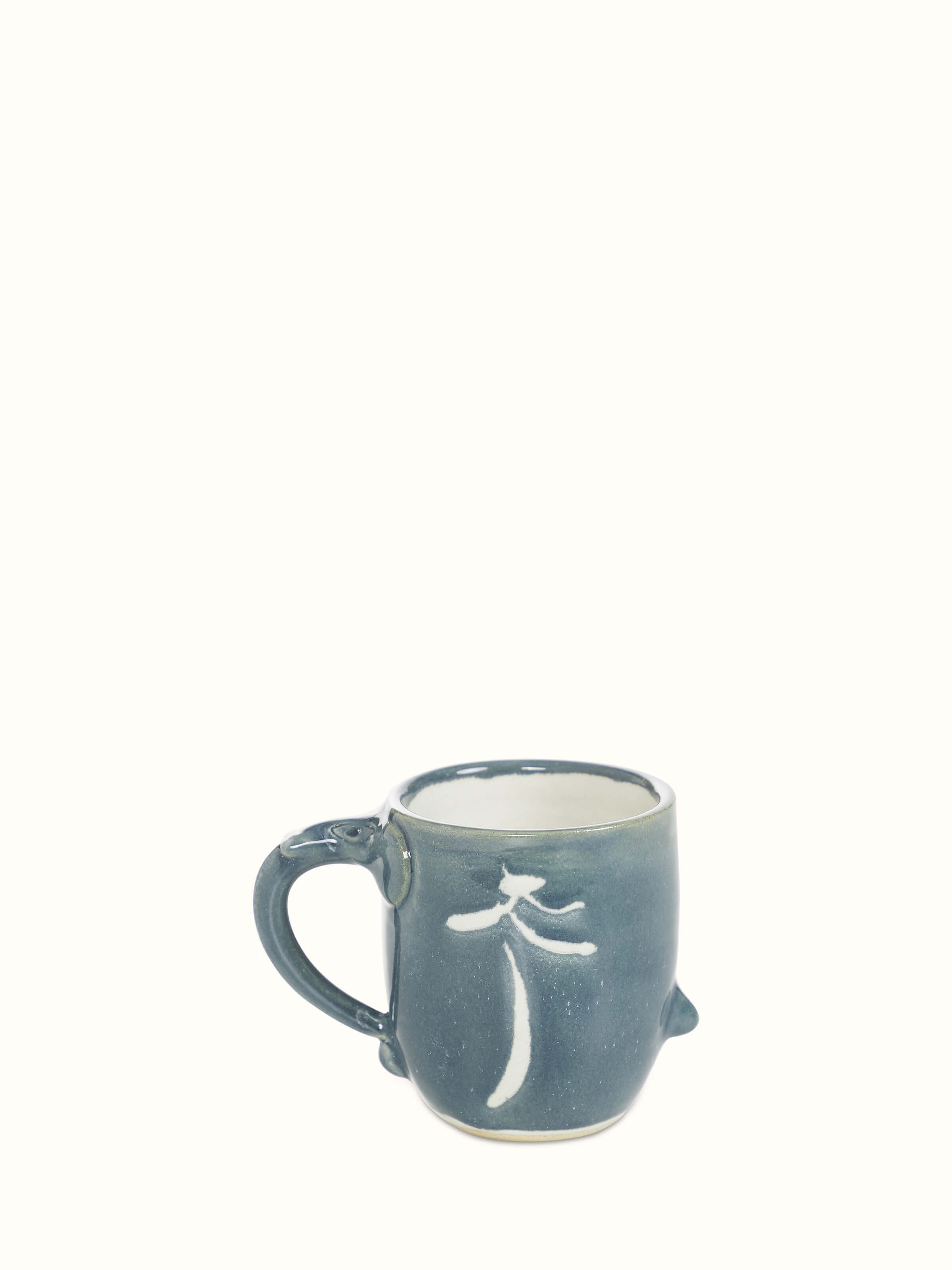 Studio pottery ceramic coffee mug in blue, showcasing its elegant design and craftsmanship.