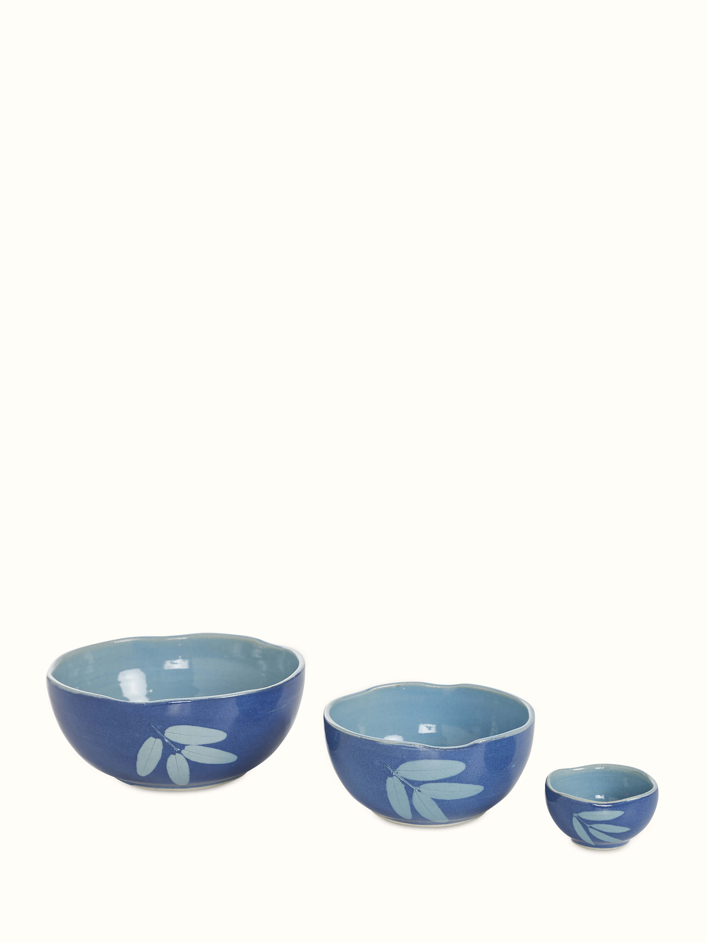 Angled view of Studio pottery ceramic serving bowls in blue (3 pcs) highlighting their craftsmanship