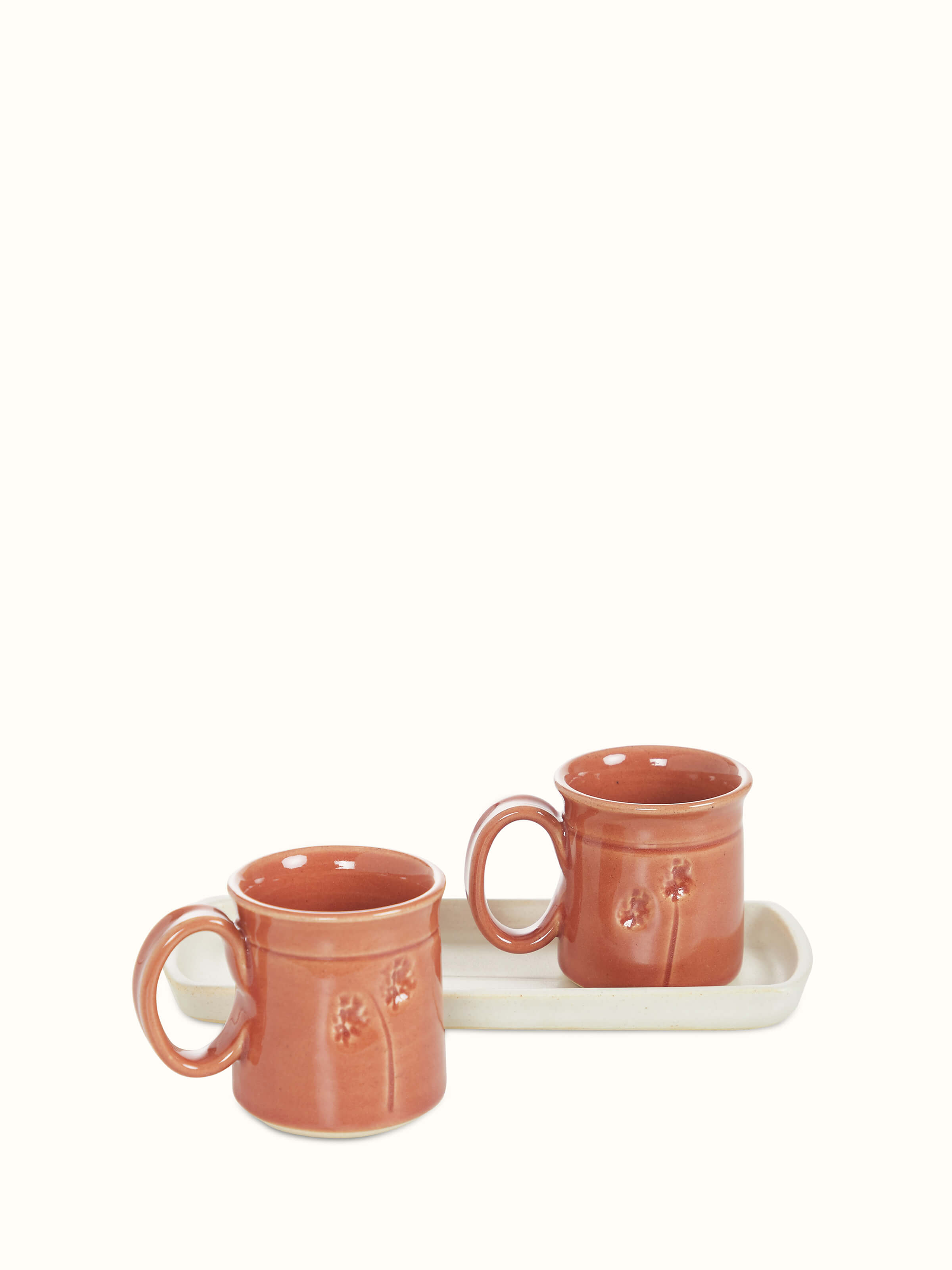 Angle view of Studio pottery ceramic coffee mugs in various colors, set of 2, showcasing the detailed glaze