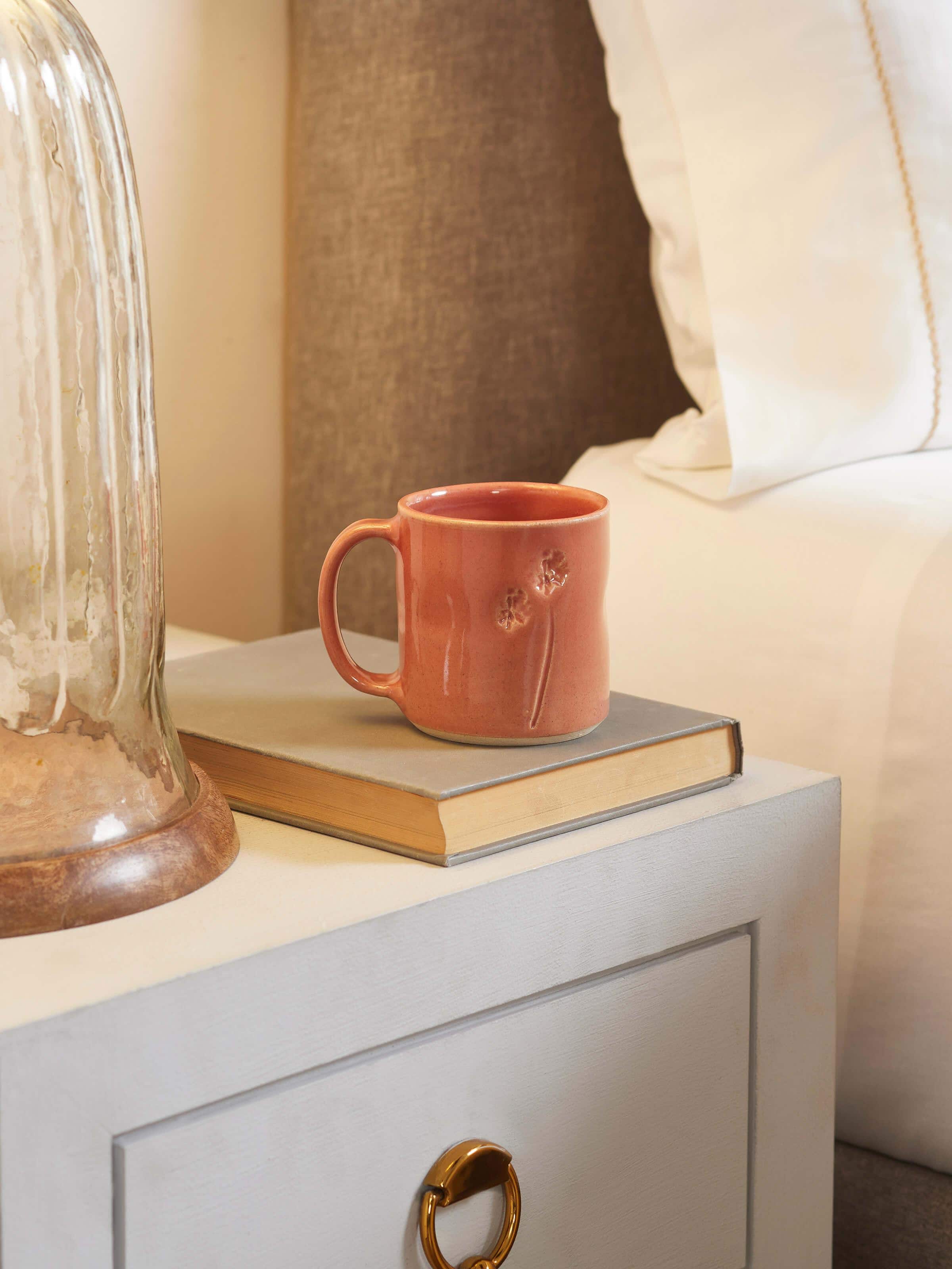 Side view of Studio pottery ceramic coffee mug in pink highlighting its smooth finish and durable ceramic material.