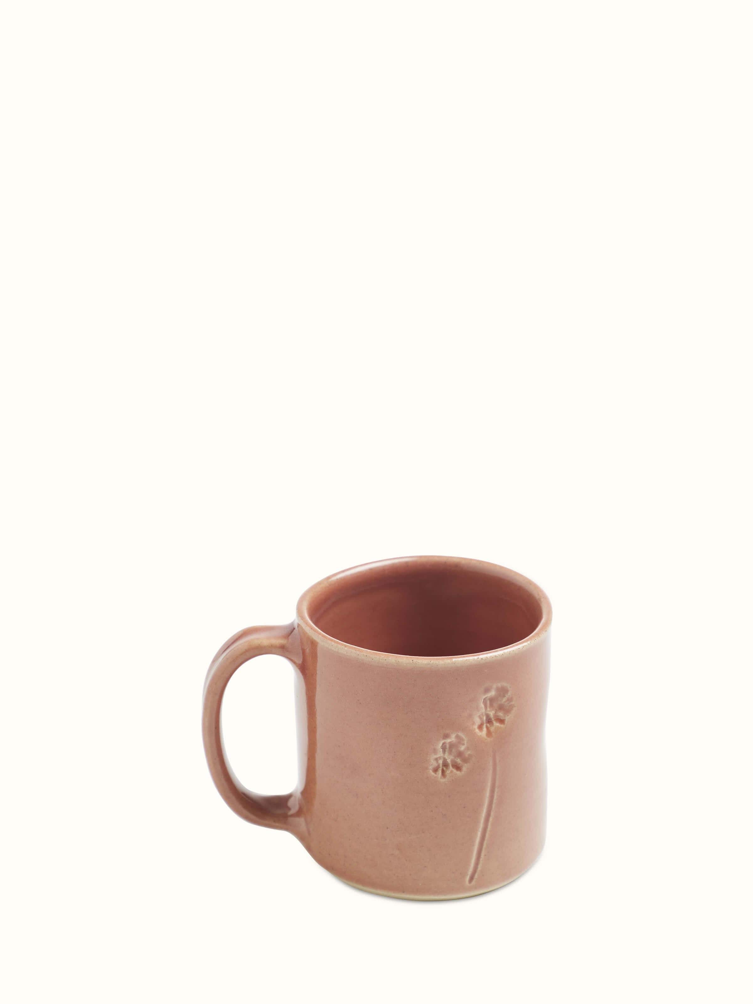 Top view of Studio pottery ceramic coffee mug in pink highlighting the smooth rim and interior finish.