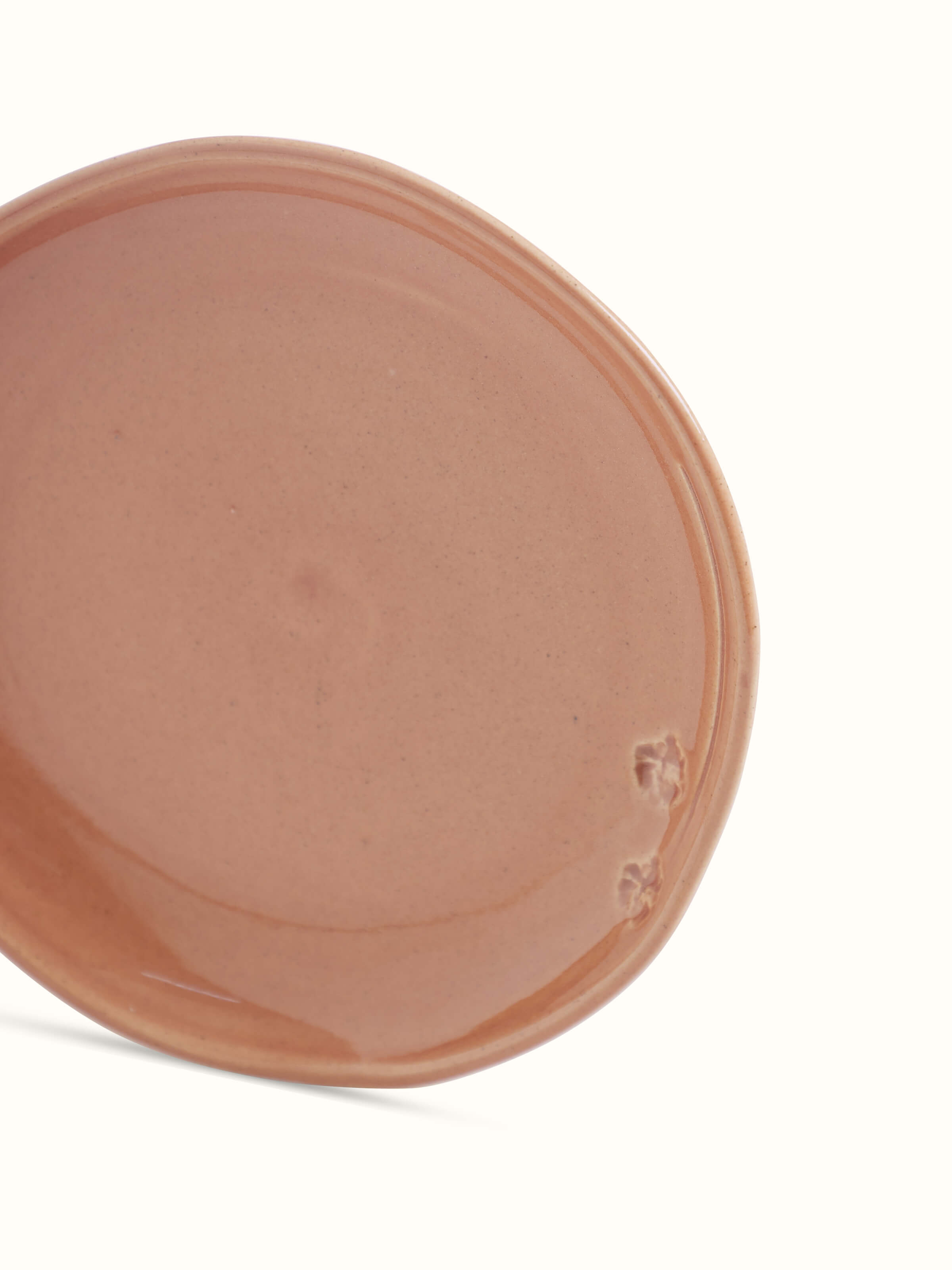 Detailed view of studio pottery ceramic dessert plate in beige, focusing on the high-quality ceramic finish and design